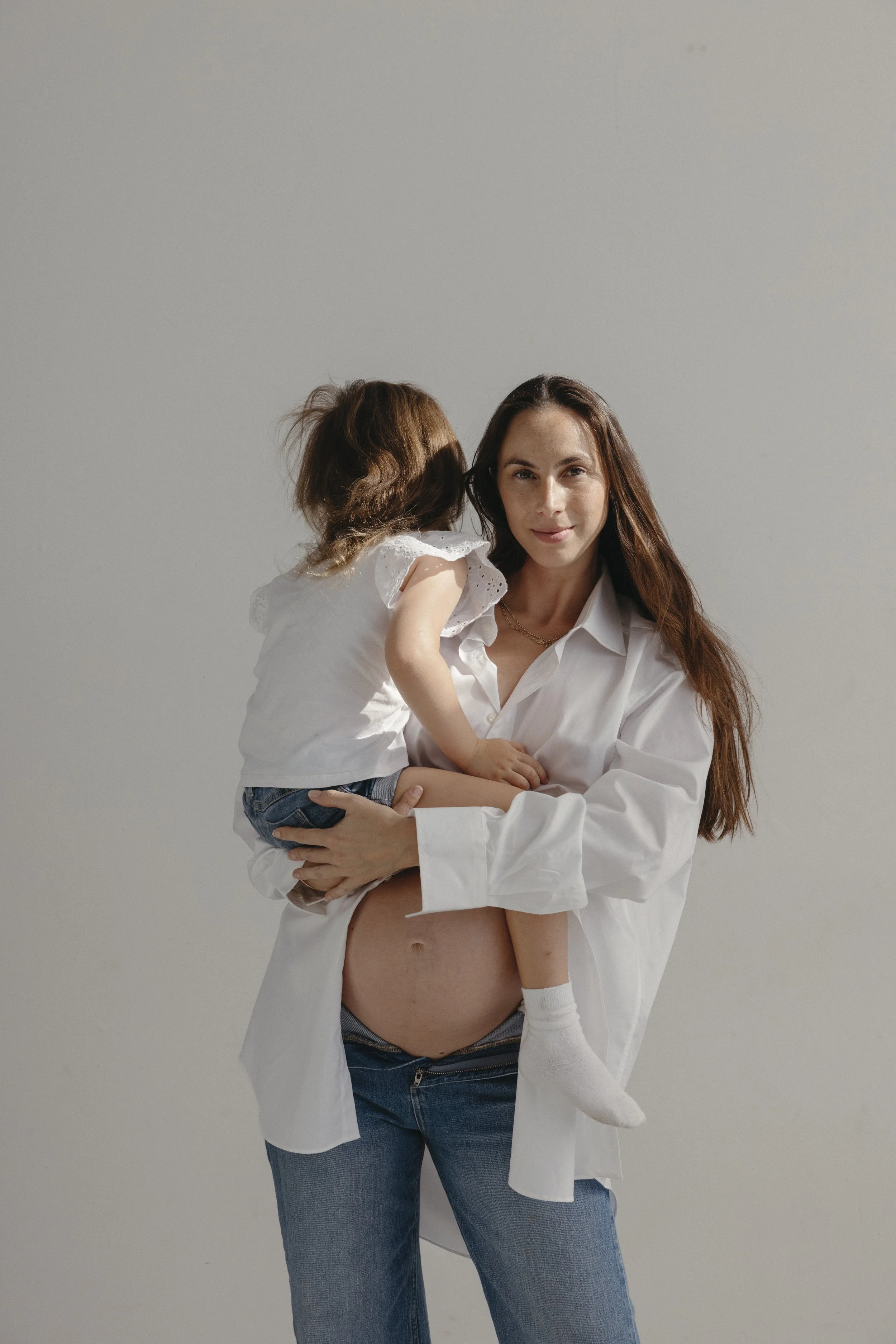 Tania Gnecchi holding her daughter, host of the Matrescence Diaries podcast