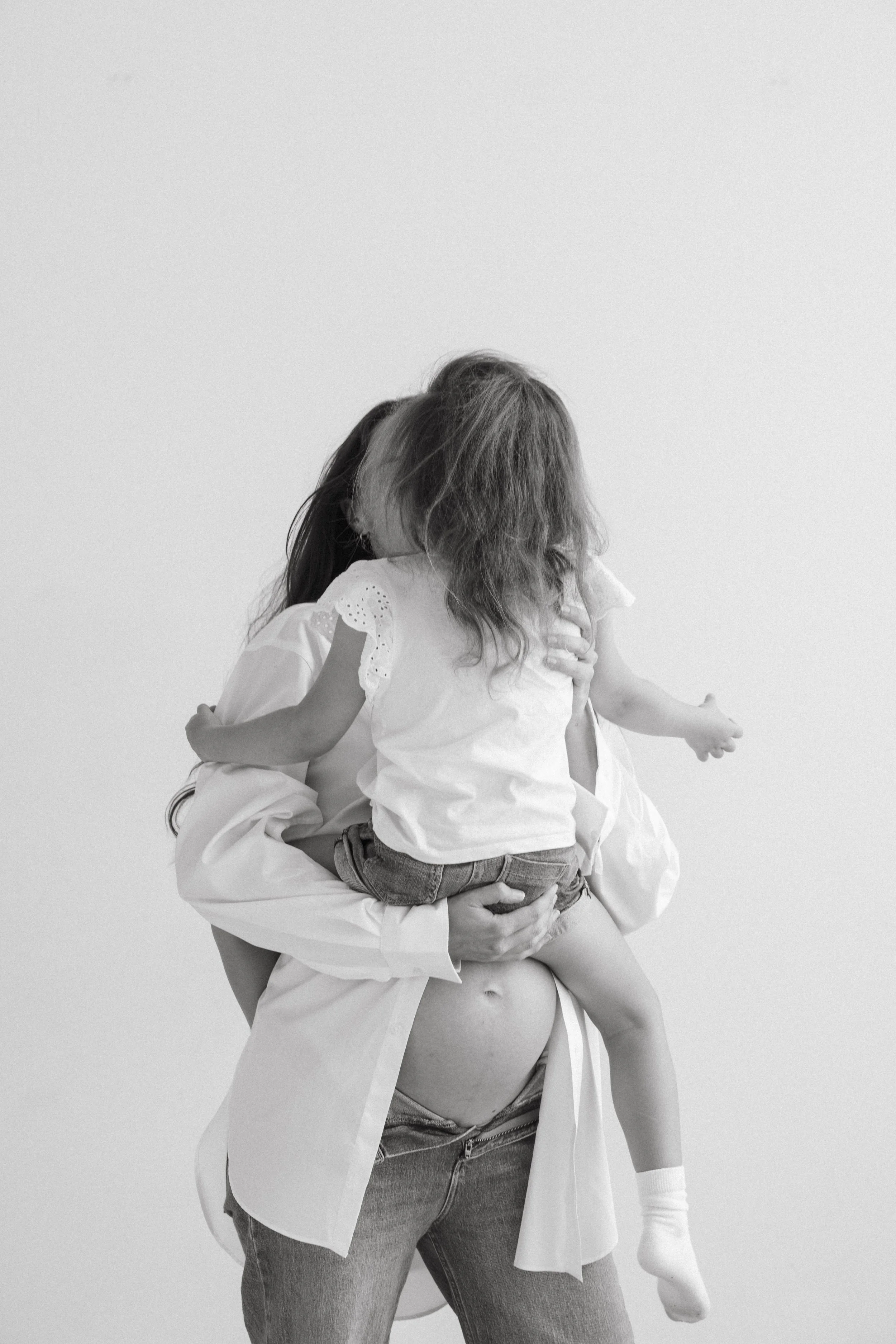 Mother and daughter laughing together, Matrescence Diaries podcast