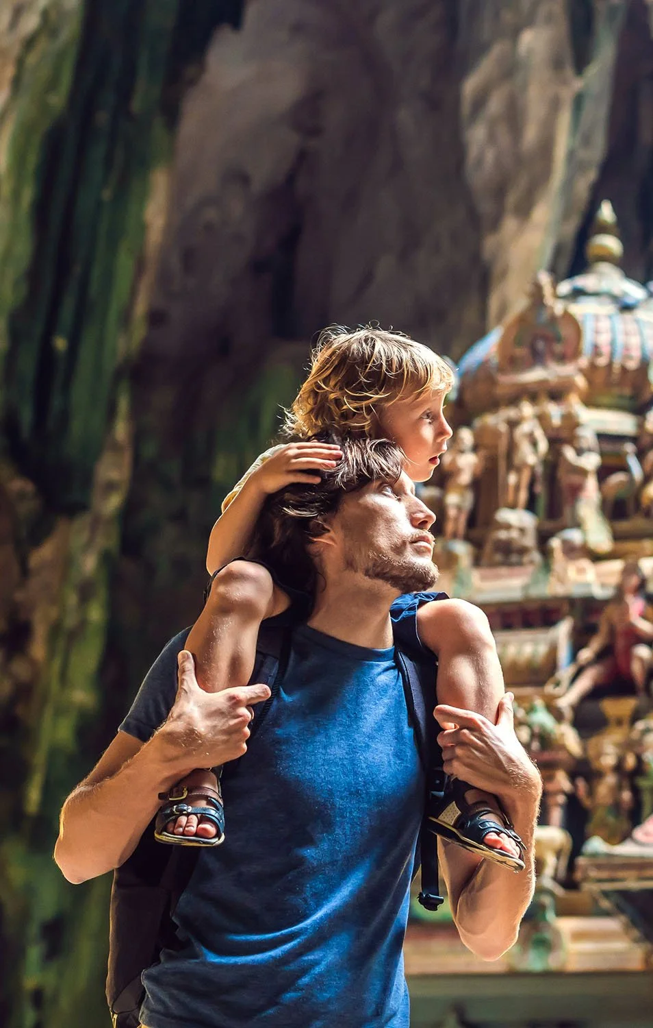 A father carrying his young son on his shoulders inside a temple, representing family aspirations, long-term financial planning, and building lasting financial security with trusted advice from Up Wealth Management.