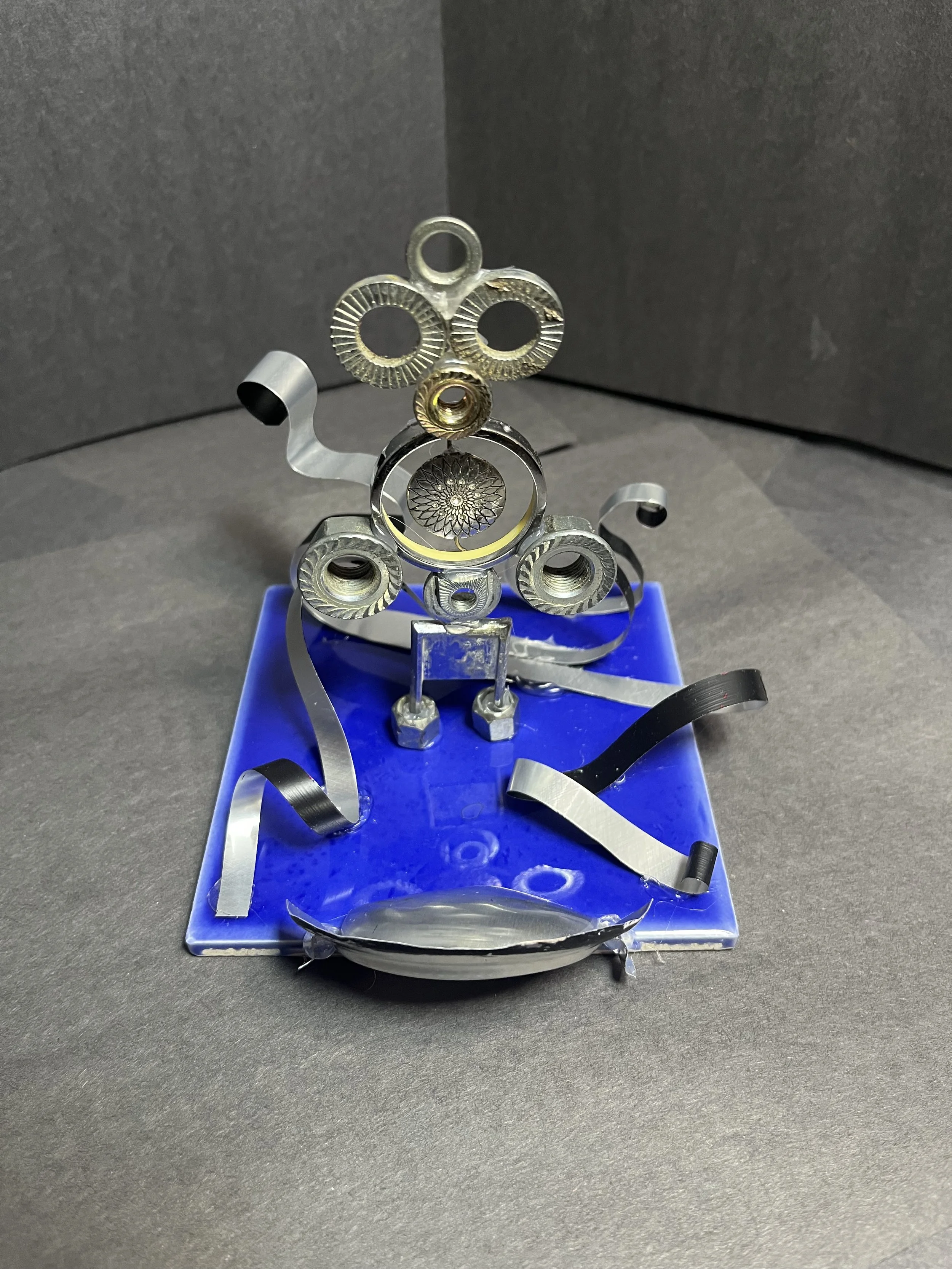 Found Object Sculpture, various metal/plastic objects, aluminum, tile & hot glue 