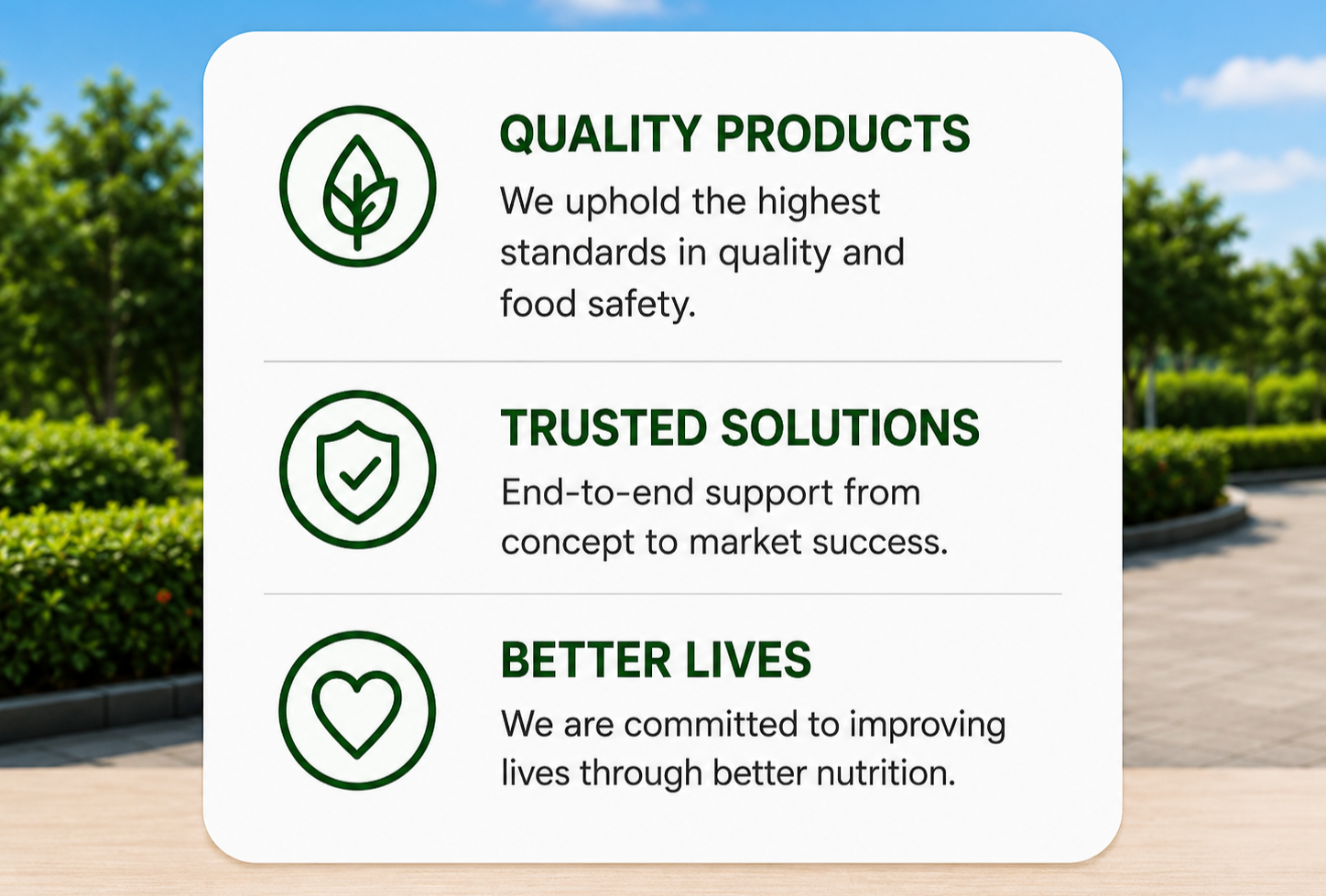 A sign in an outdoor setting with three sections, each with a green icon and text. The first section has a leaf icon and says 'QUALITY PRODUCTS: We uphold the highest standards in quality and food safety.' The second has a shield with a checkmark and says 'TRUSTED SOLUTIONS: End-to-end support from concept to market success.' The third has a heart icon and says 'BETTER LIVES: We are committed to improving lives through better nutrition.'