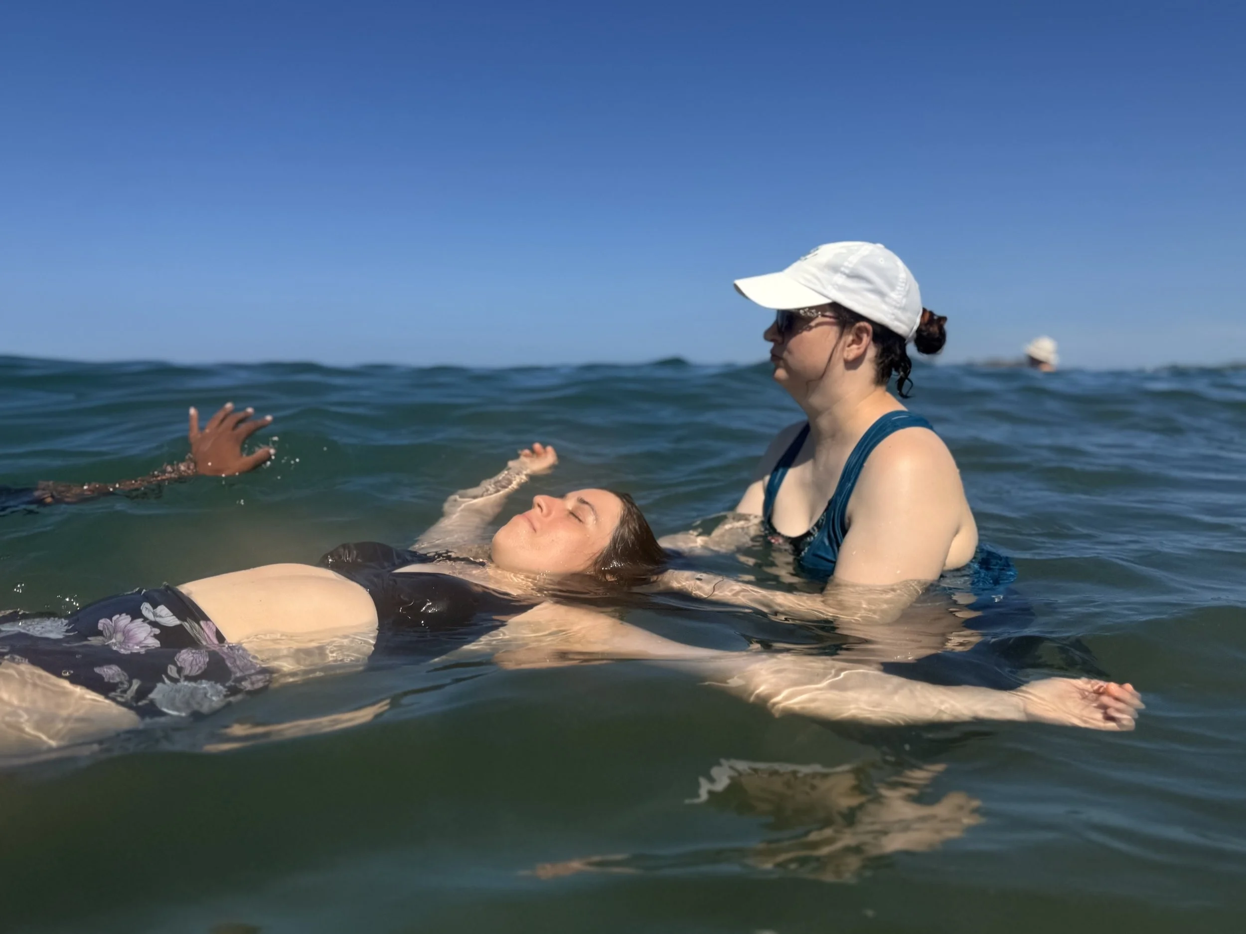 Brandy is in the ocean performing craniosacral therapy on another student at CRSMT in Costa Rica.