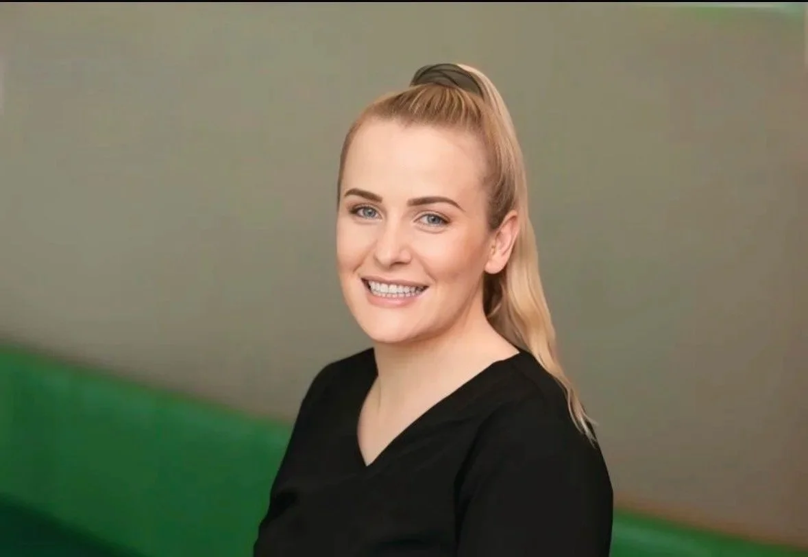 Loretta Facey Nurse Practitoner, wearing a black top, smiling at the camera.