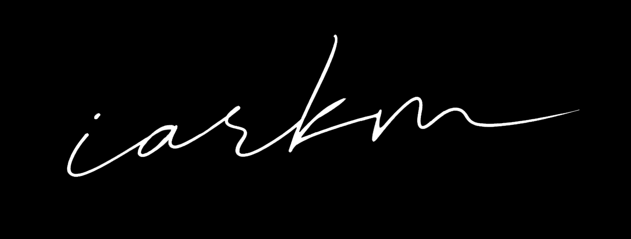 White handwritten text reading 'i am' on a black background.
