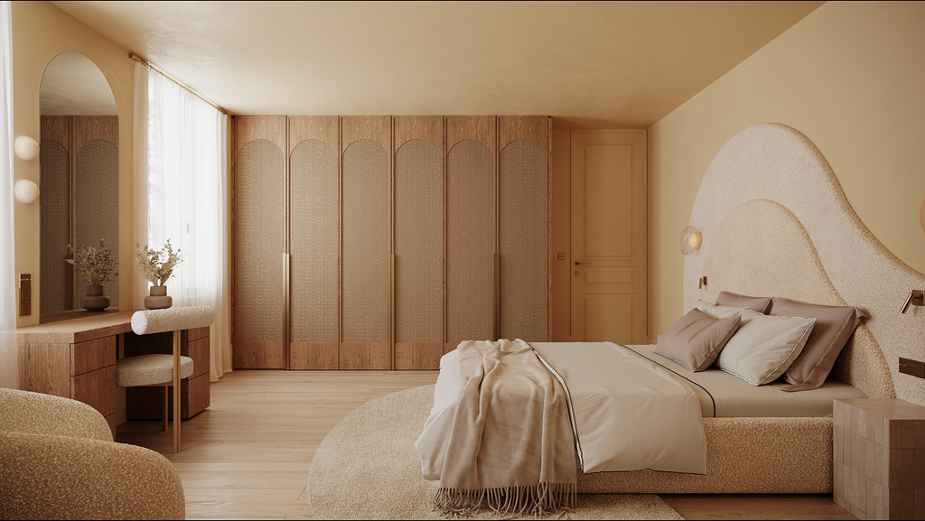 Chambre moderne avec lit double, décor beige, armoire en bois, bureau avec deux vases de fleurs, fauteuil, éclairage doux, rideaux légers.
