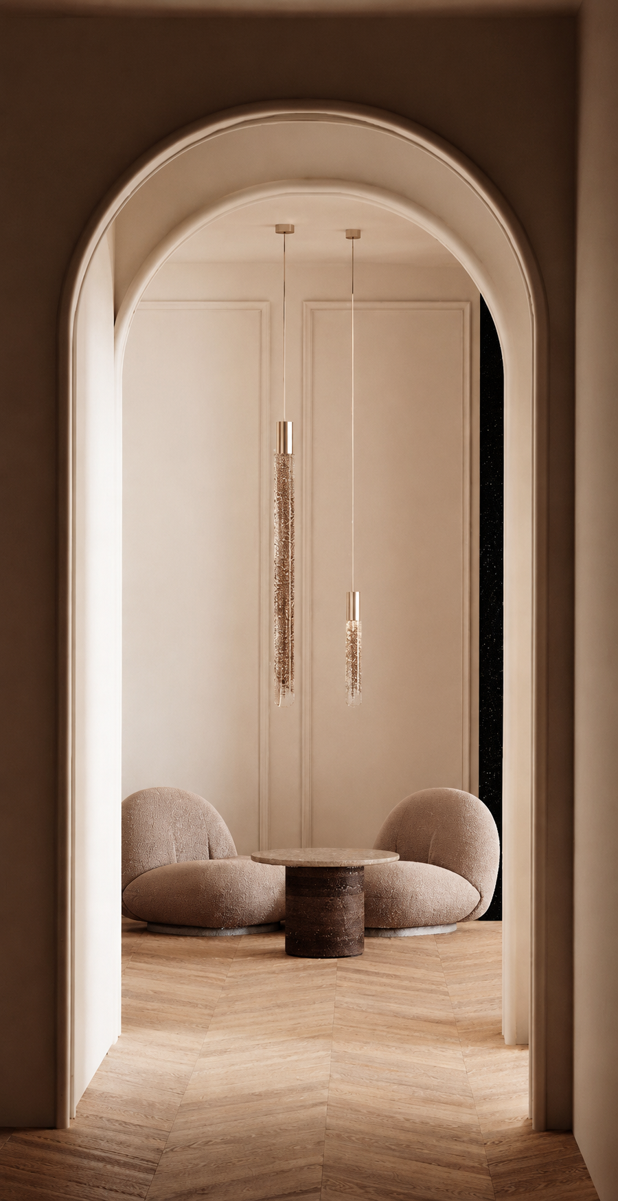 Coin salon avec deux fauteuils arrondis et une petite table, illuminée par deux suspensions hangings modernes.