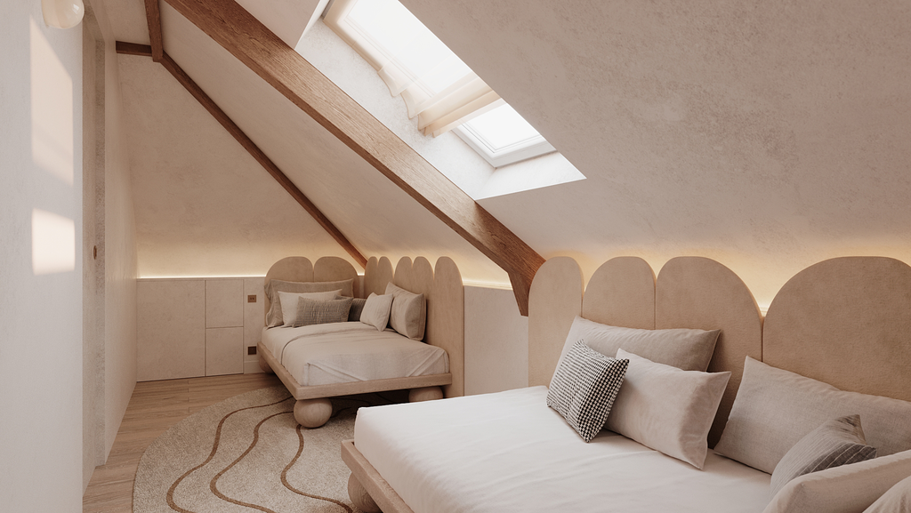 Chambre avec un lit et un canapé sous un toit en pente avec une lucarne. Décor neutre et minimaliste.