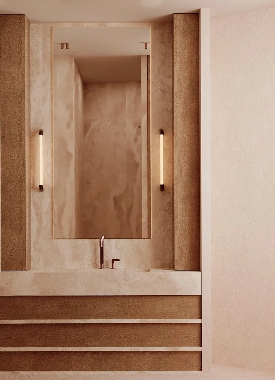 Un miroir encadré dans une salle de bain moderne en tons neutres, flanqué de deux lampes verticales, avec un lavabo sous le miroir.