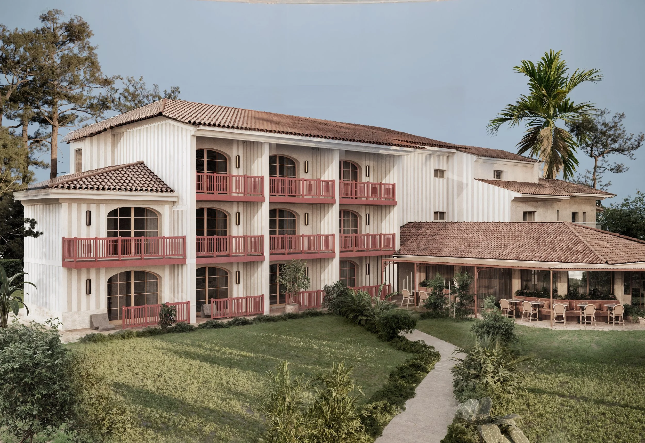 Un bâtiment résidentiel avec plusieurs étages, des balcons en bois rouge et de grandes fenêtres, entouré d'un jardin vert avec des arbustes et des arbres, sous un ciel sans nuages.