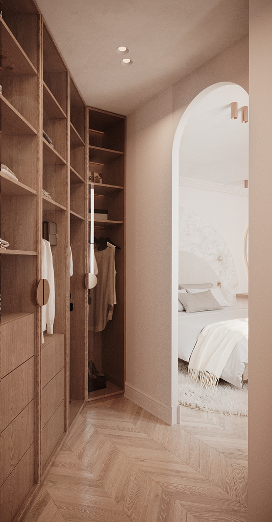 Coin salon avec étagères en bois et un placard, donnant sur une chambre avec un lit et une décoration neutre.