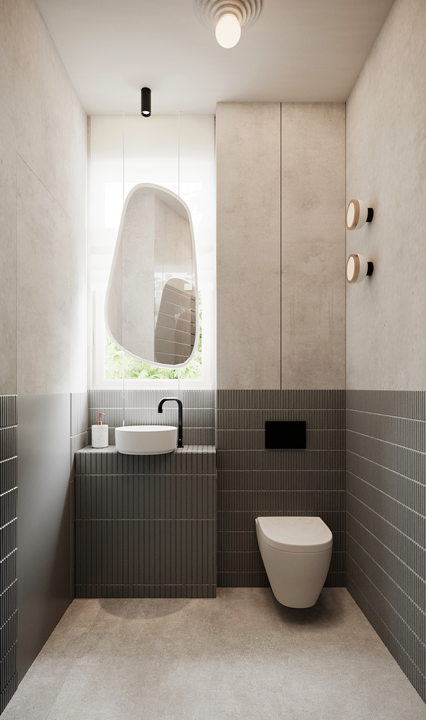 Petite salle de bain moderne avec un miroir suspendu, un lavabo rond, un lavabo noir, un wc suspendu, murs gris clairs avec carrelage en bas, et un éclairage minimaliste.