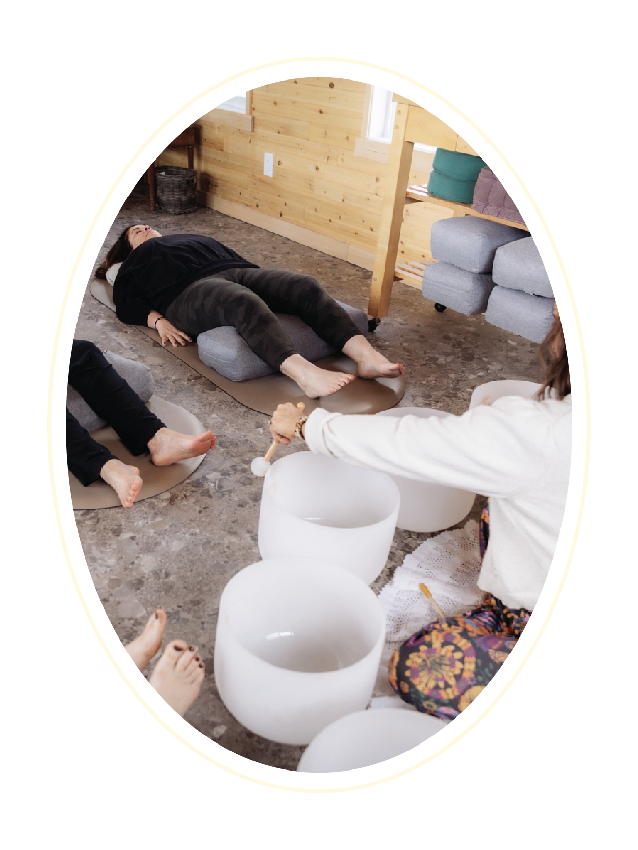Participants relaxing on yoga mats during a sound healing session at Gathered Hearth Studio in Prince Albert