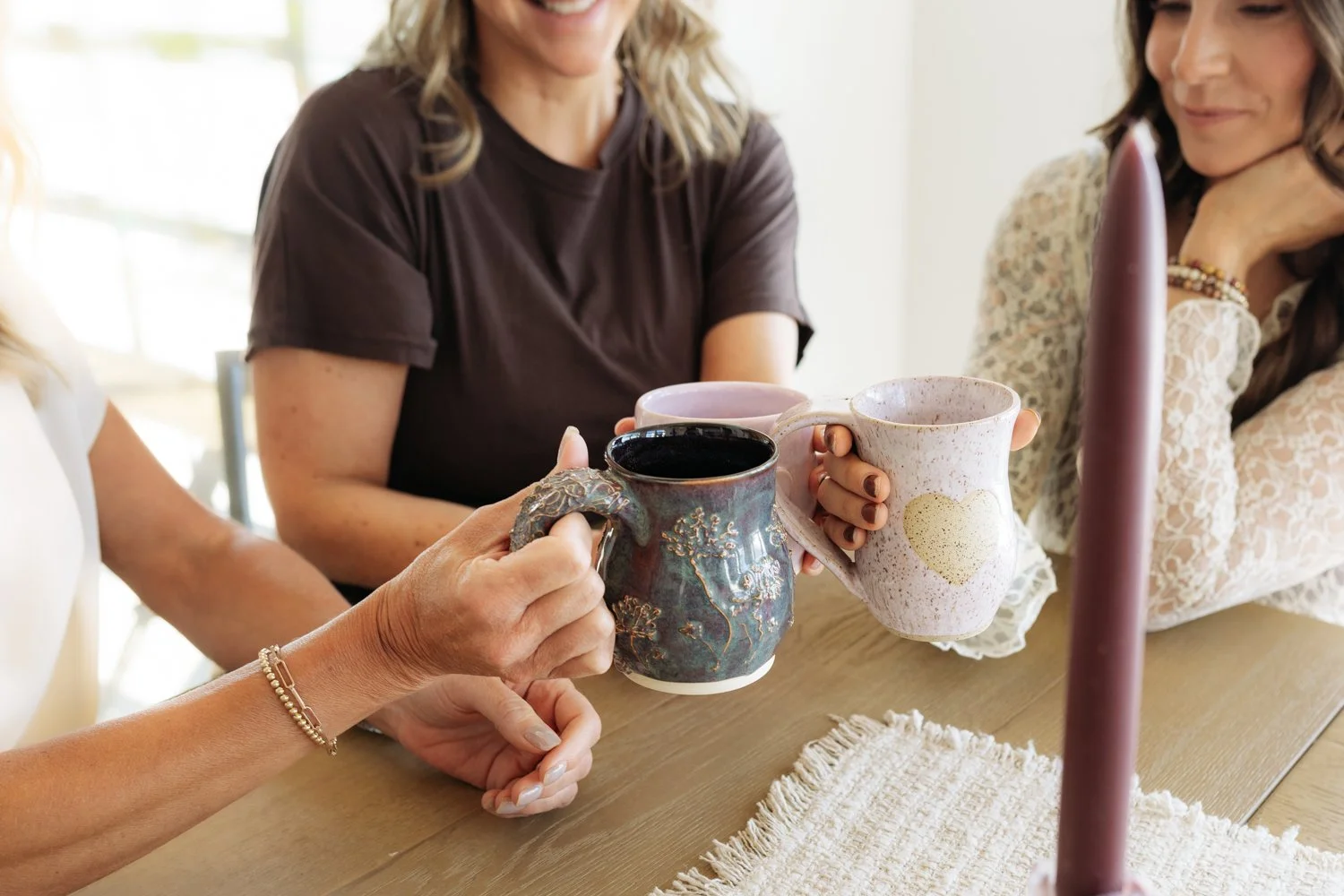 Members having tea in ceramic mugs at Gathered Hearth, market and studio in Prince Albert