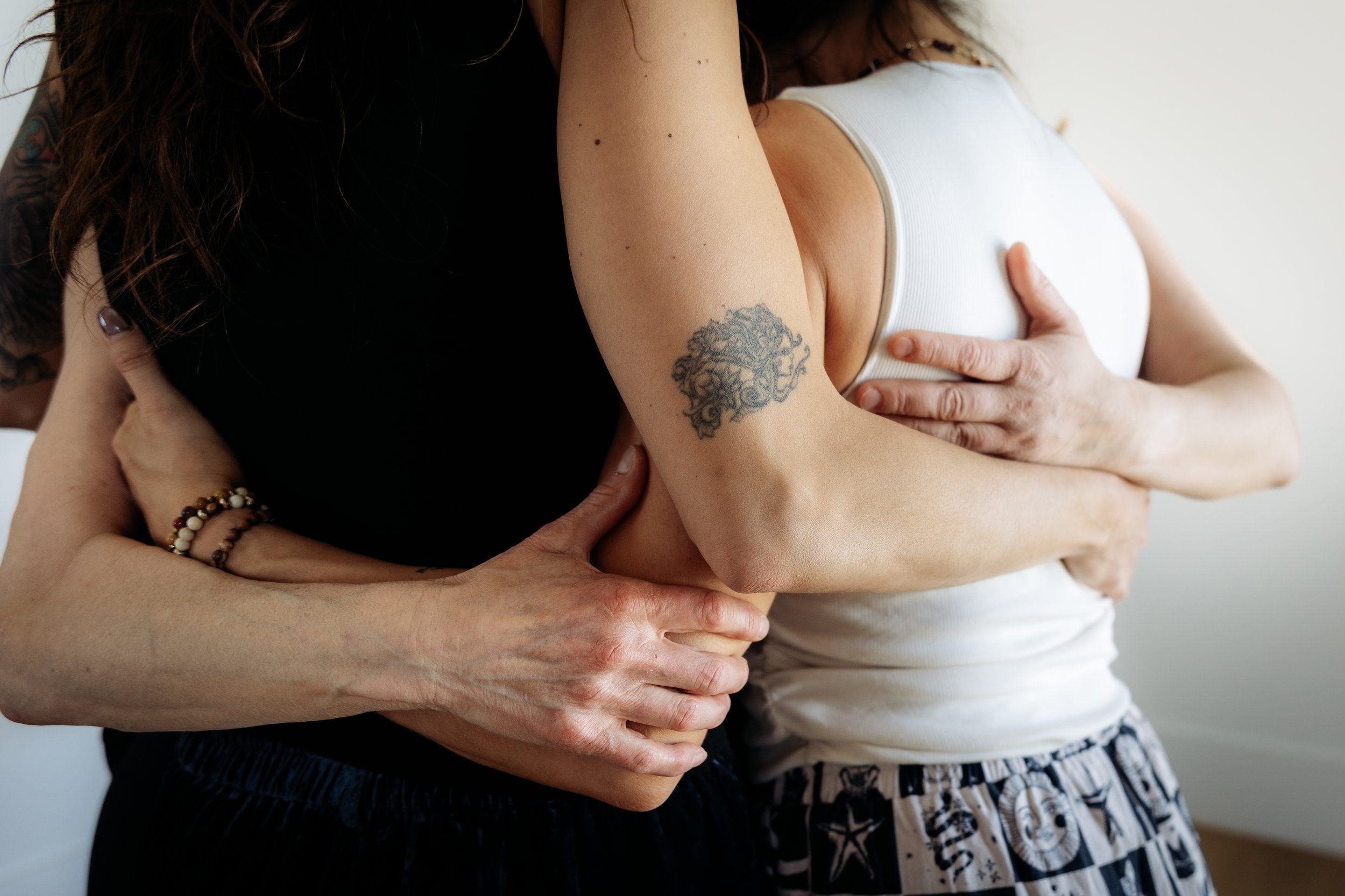 Women in a group embrace at Gathered Hearth in Prince Albert