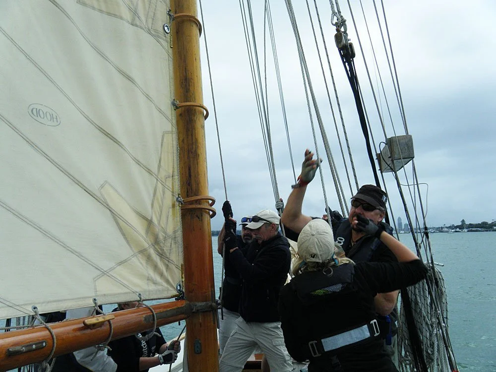 Tightening the topsail halyard and sheet.