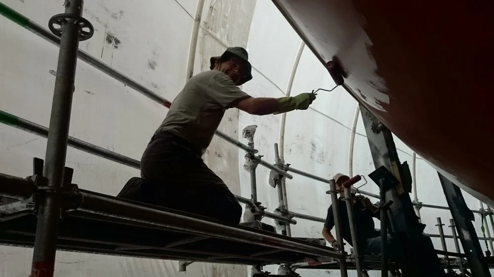 Crew member and friend of CYCT Frank helping apply the antifouling before relaunching after the topsides repairs and repaint.