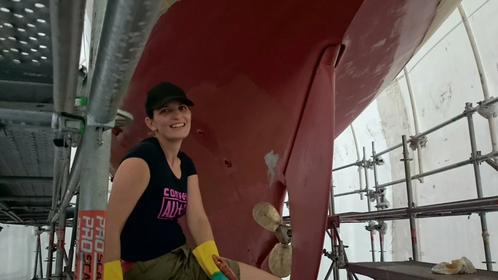Friend of CYCT and crew member Catherine helping with the antifouling.