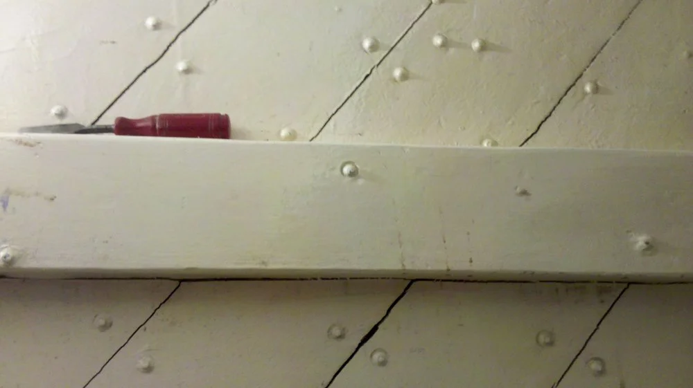 Starboard bow cracks from drying timbers and hull movement.