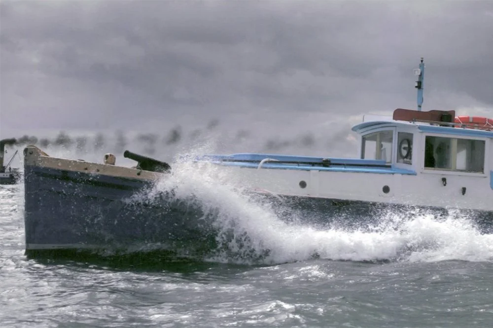 A boat speeding through choppy waters, creating a large splash and waves under a cloudy sky.