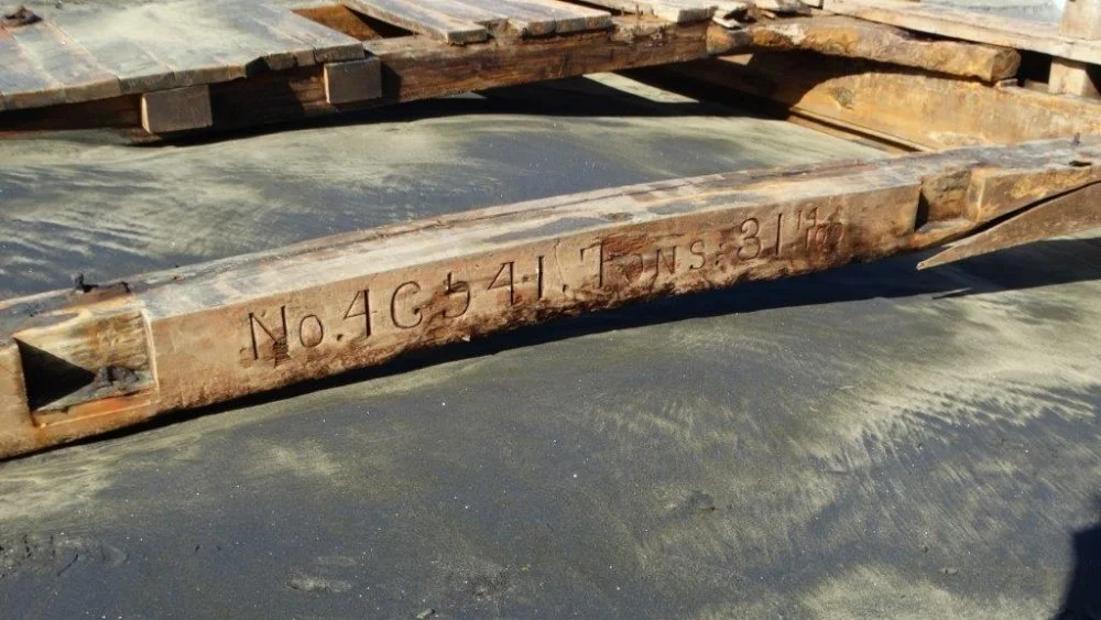 The registration beam with the hull full of sand below.