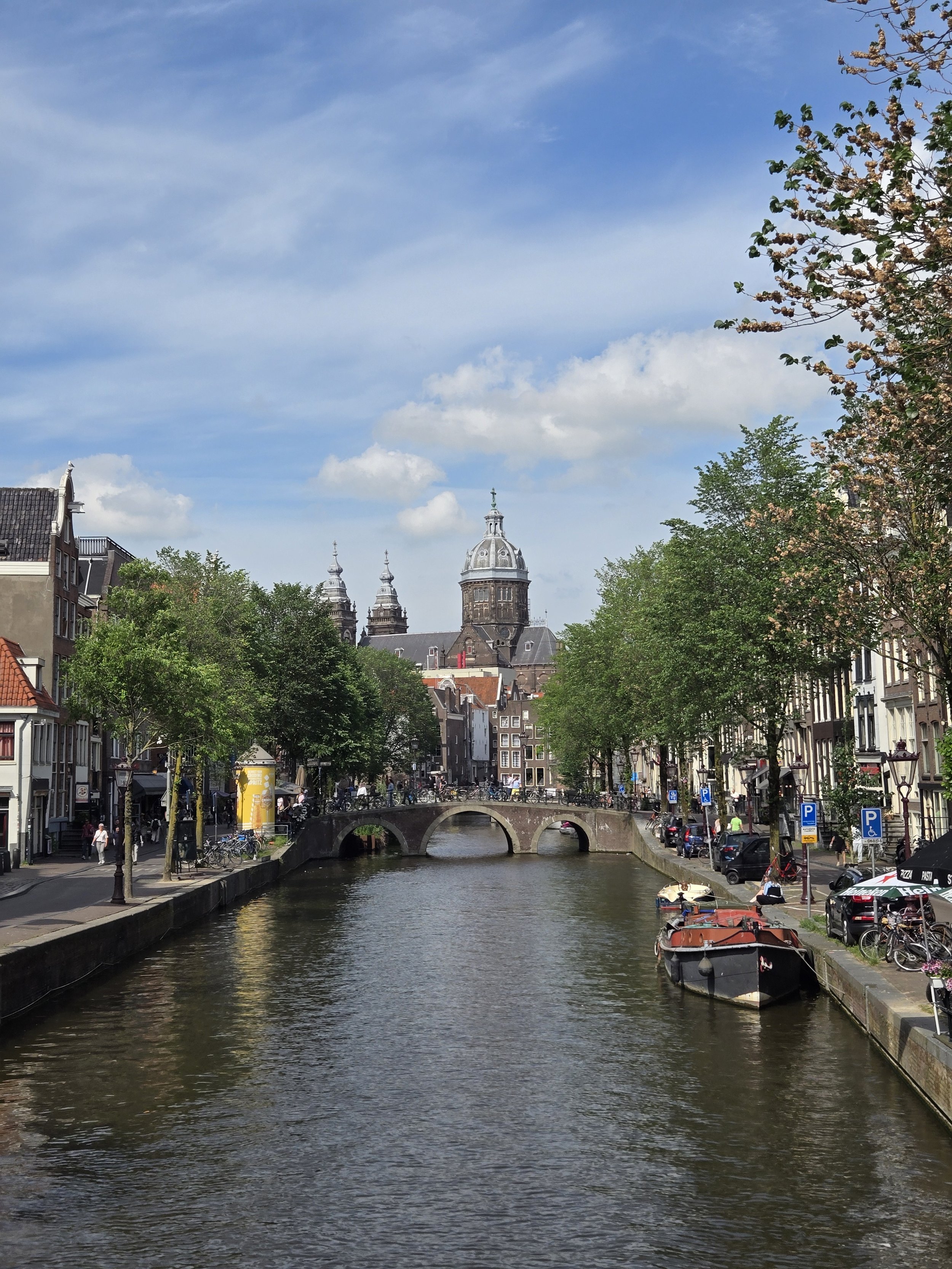 Historic canal in Amsterdam and St. Nicholas basilica