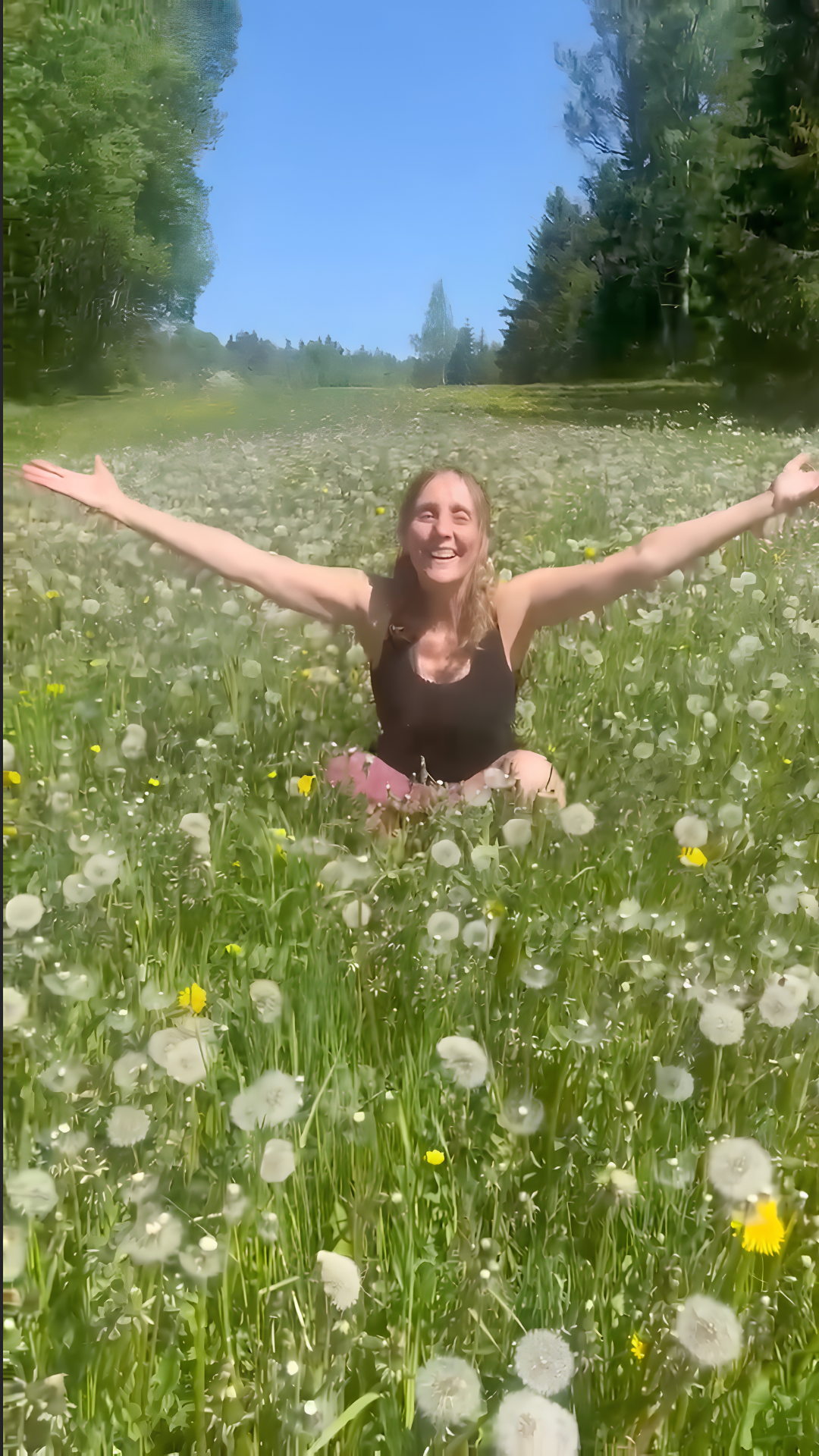 A happy and positive smile of Annica Hill in the middle of a flower field.