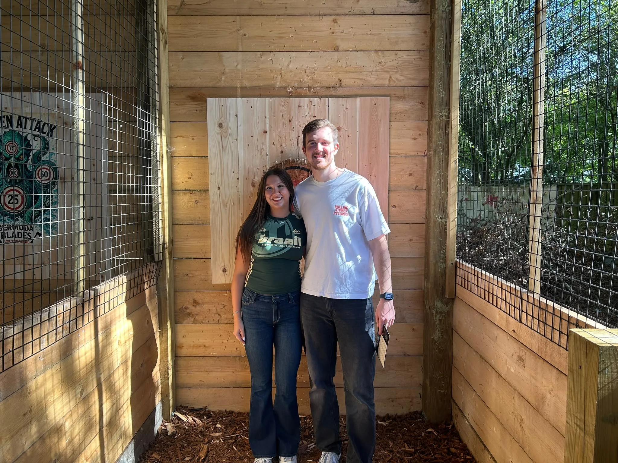 Two guests enjoying a session in the covered throwing lane at Bermuda Blades