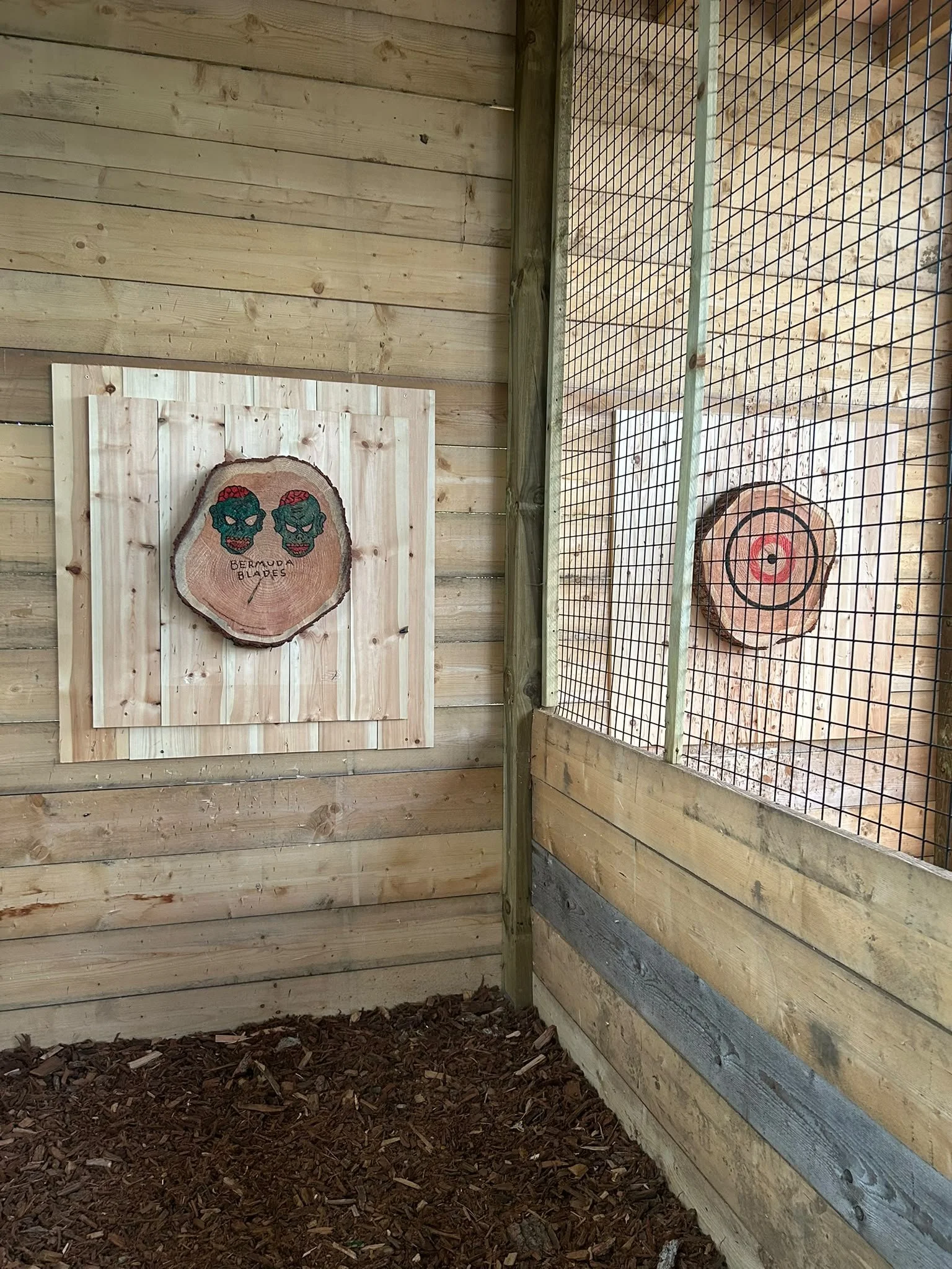 Two themed target boards in the covered axe throwing lane at Bermuda Blades
