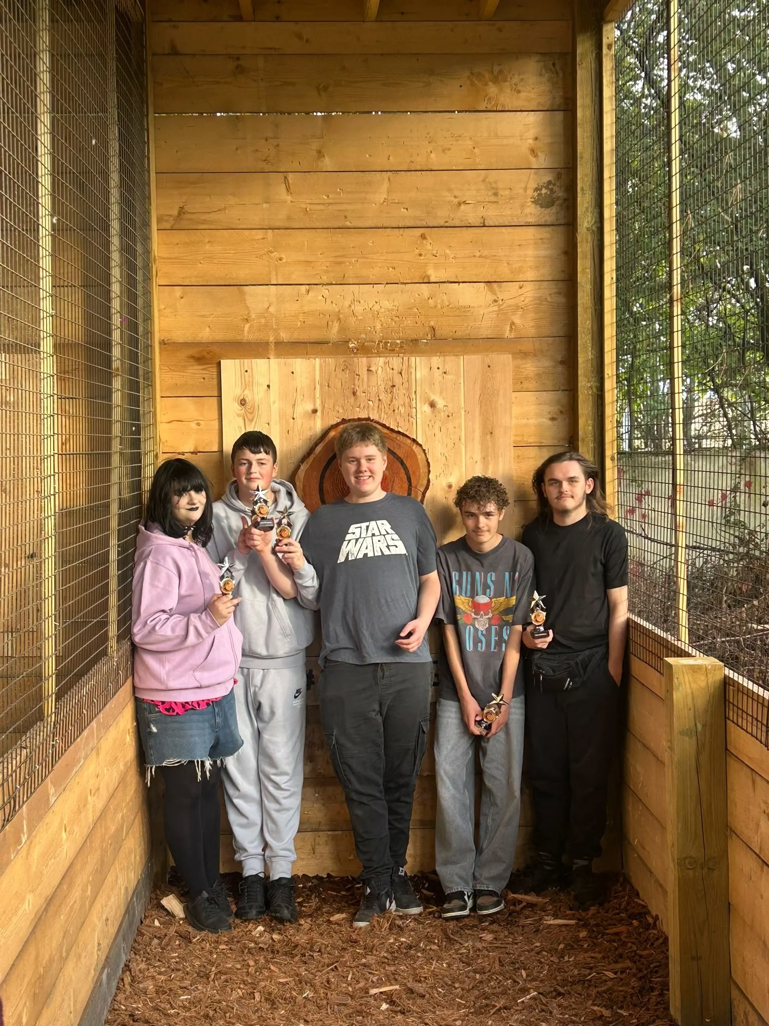Five children celebrating an axe throwing session at Bermuda Blades