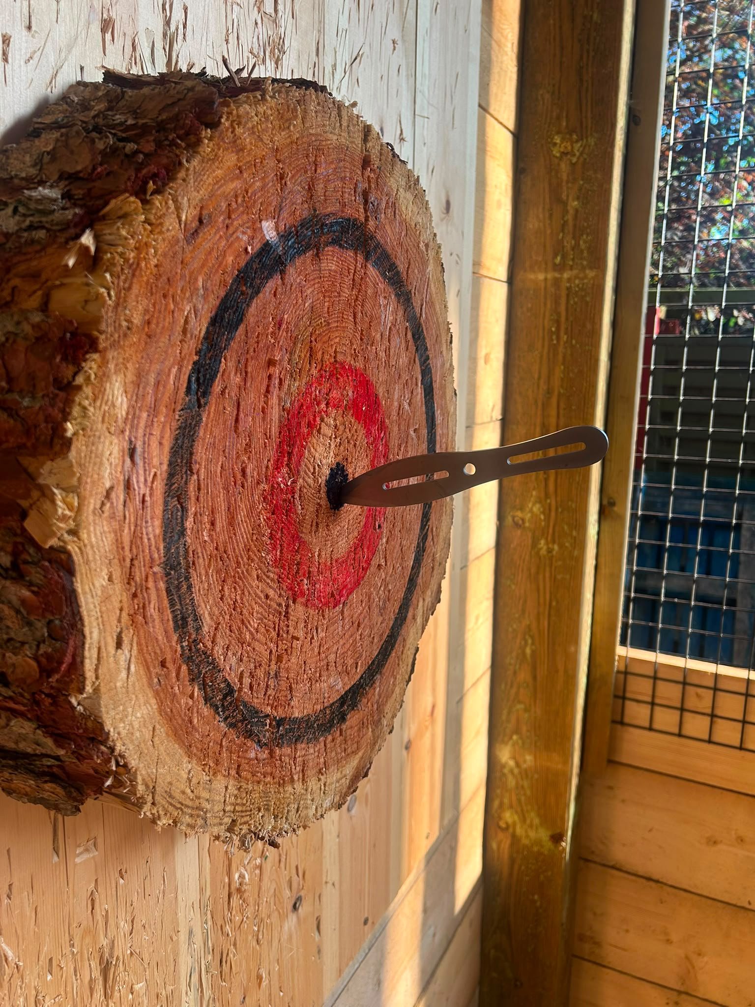 Knife hitting the wooden bullseye target at Bermuda Blades