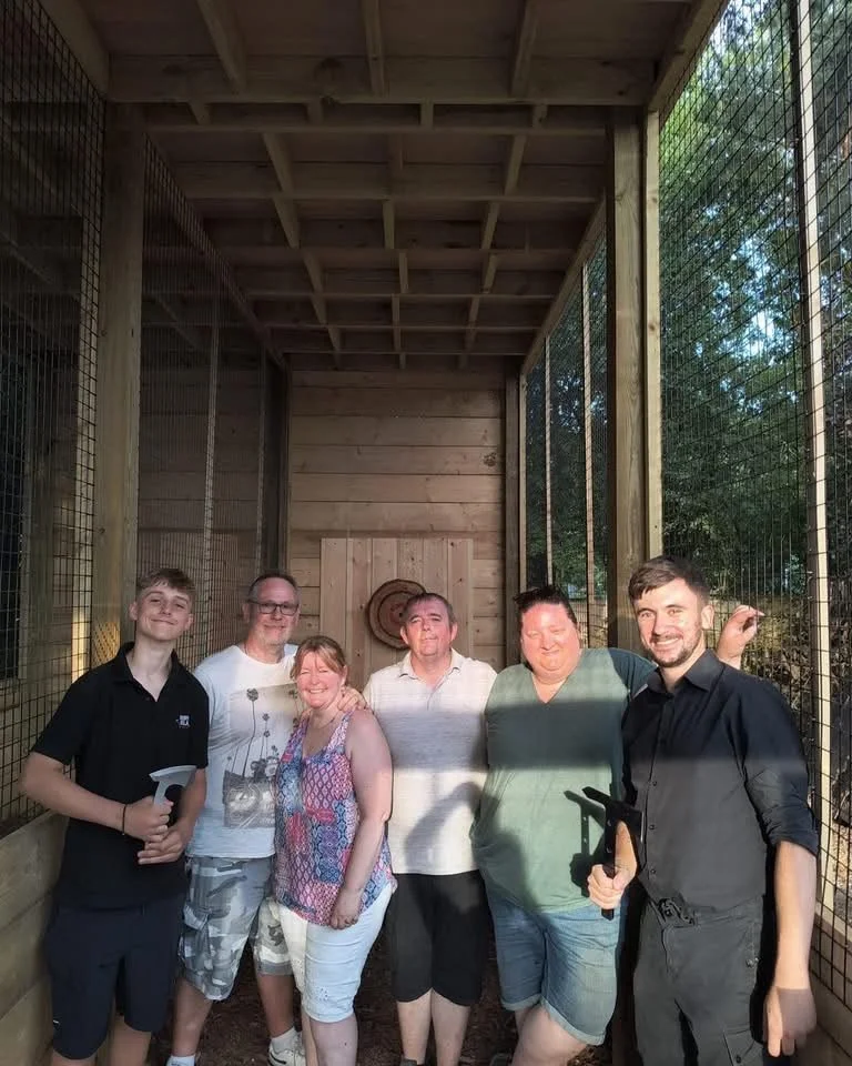 Group of guests posing together at Bermuda Blades axe throwing in Henlow