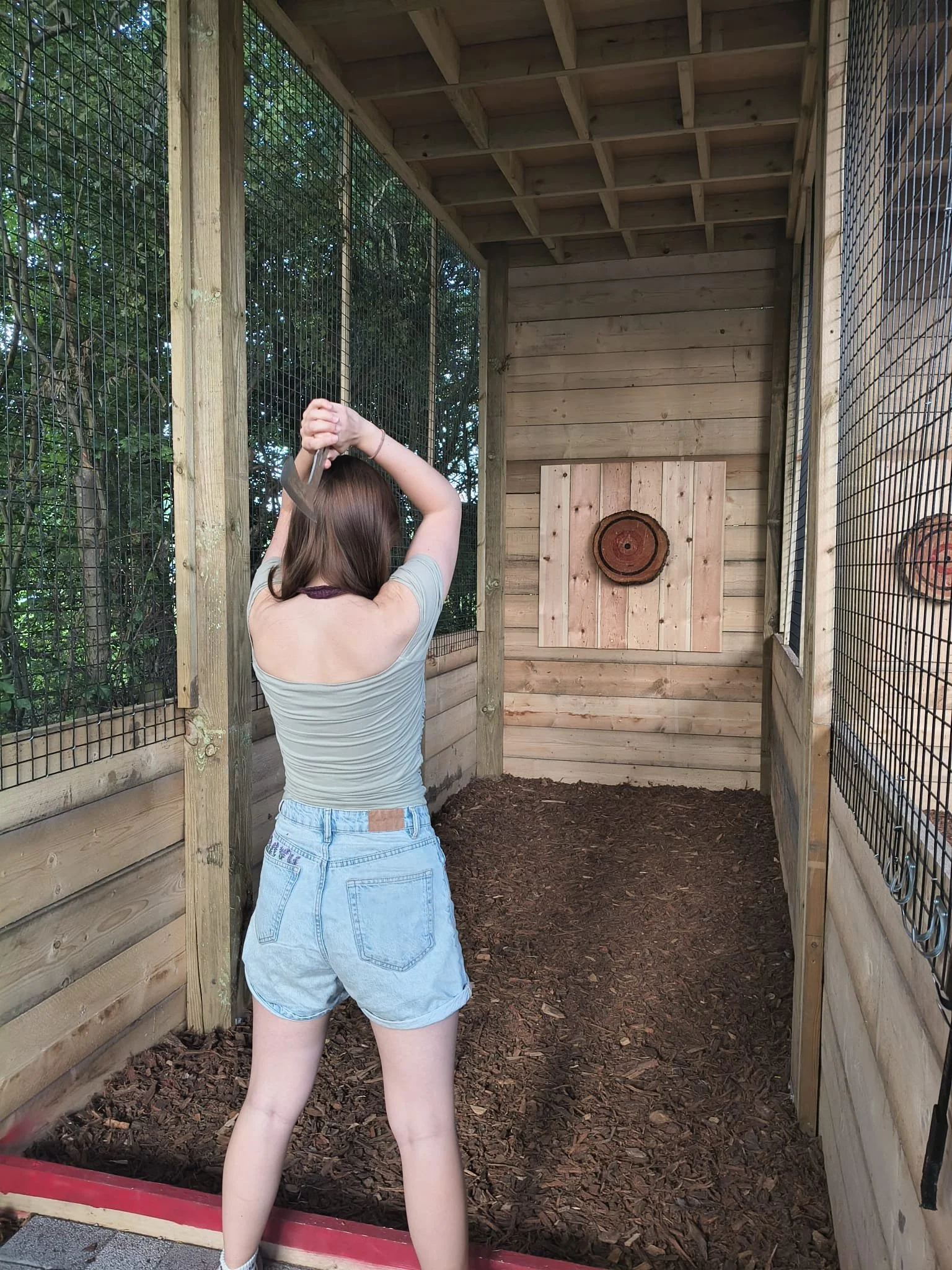 A customer taking aim during an axe throwing session at Bermuda Blades' covered outdoor venue in Henlow, Bedfordshire.