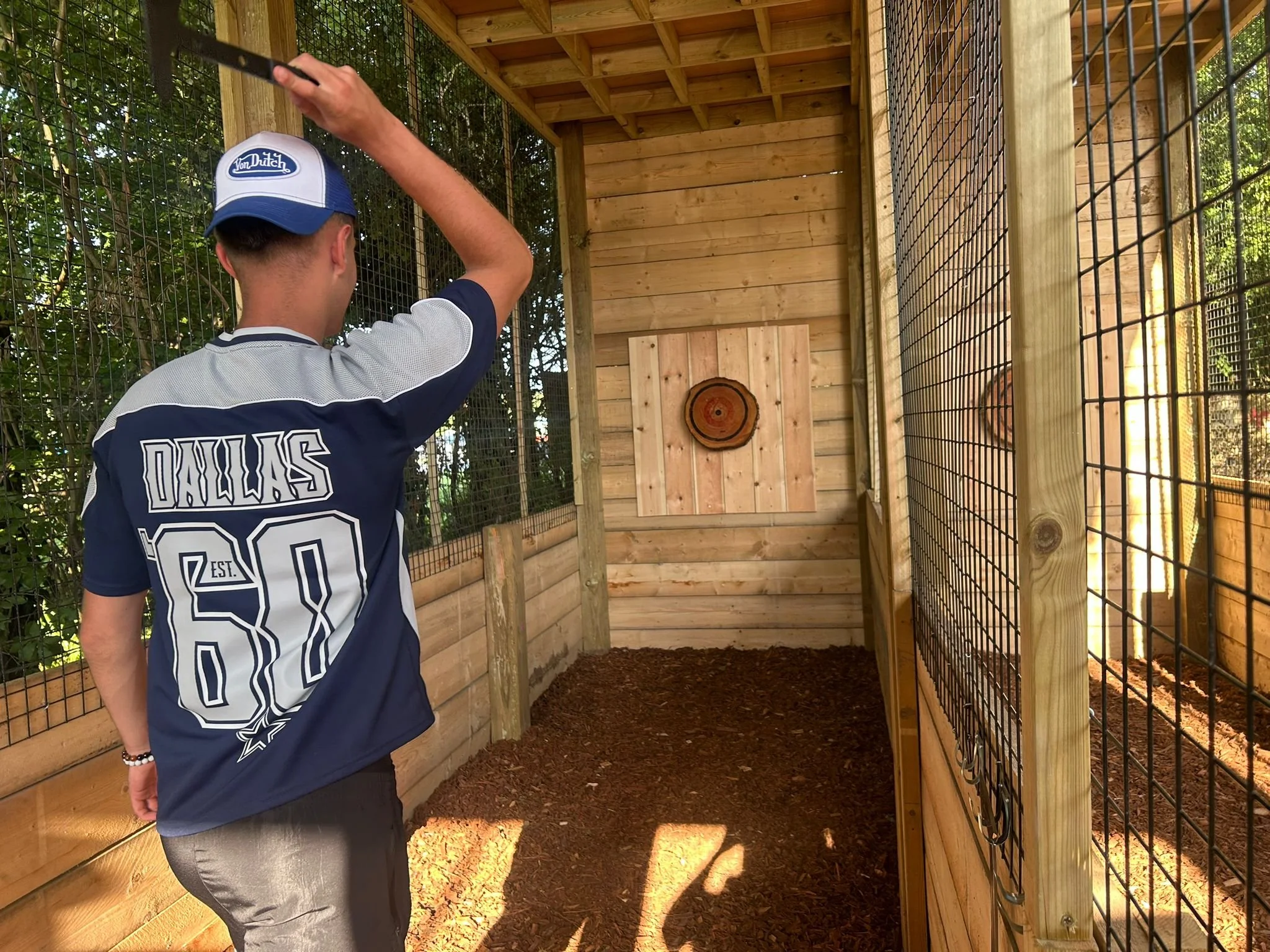 A customer taking aim during an axe throwing session at Bermuda Blades' covered outdoor venue in Henlow, Bedfordshire.