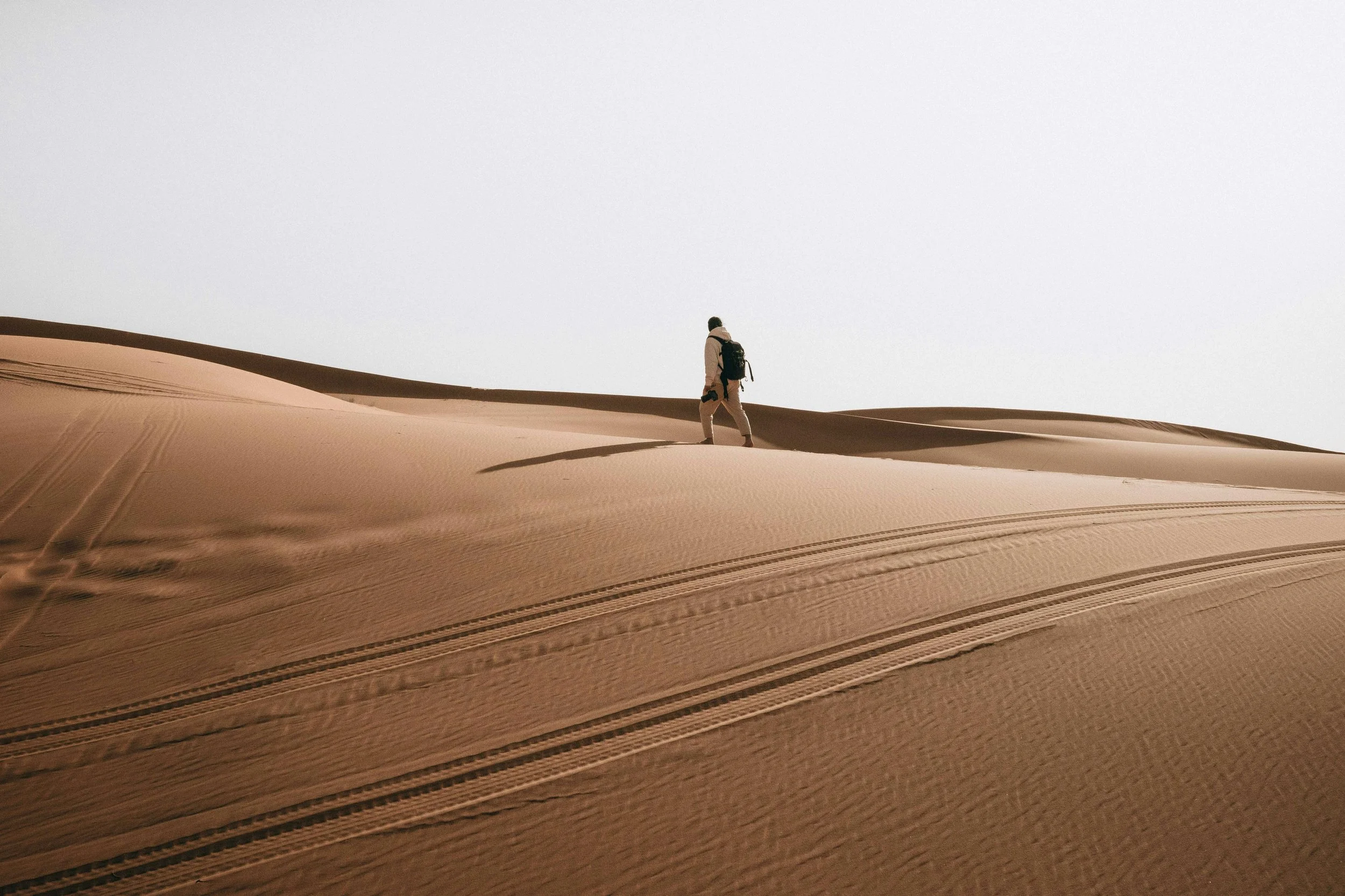 Figure walking on a sand dune - eastern Saudi Arabia