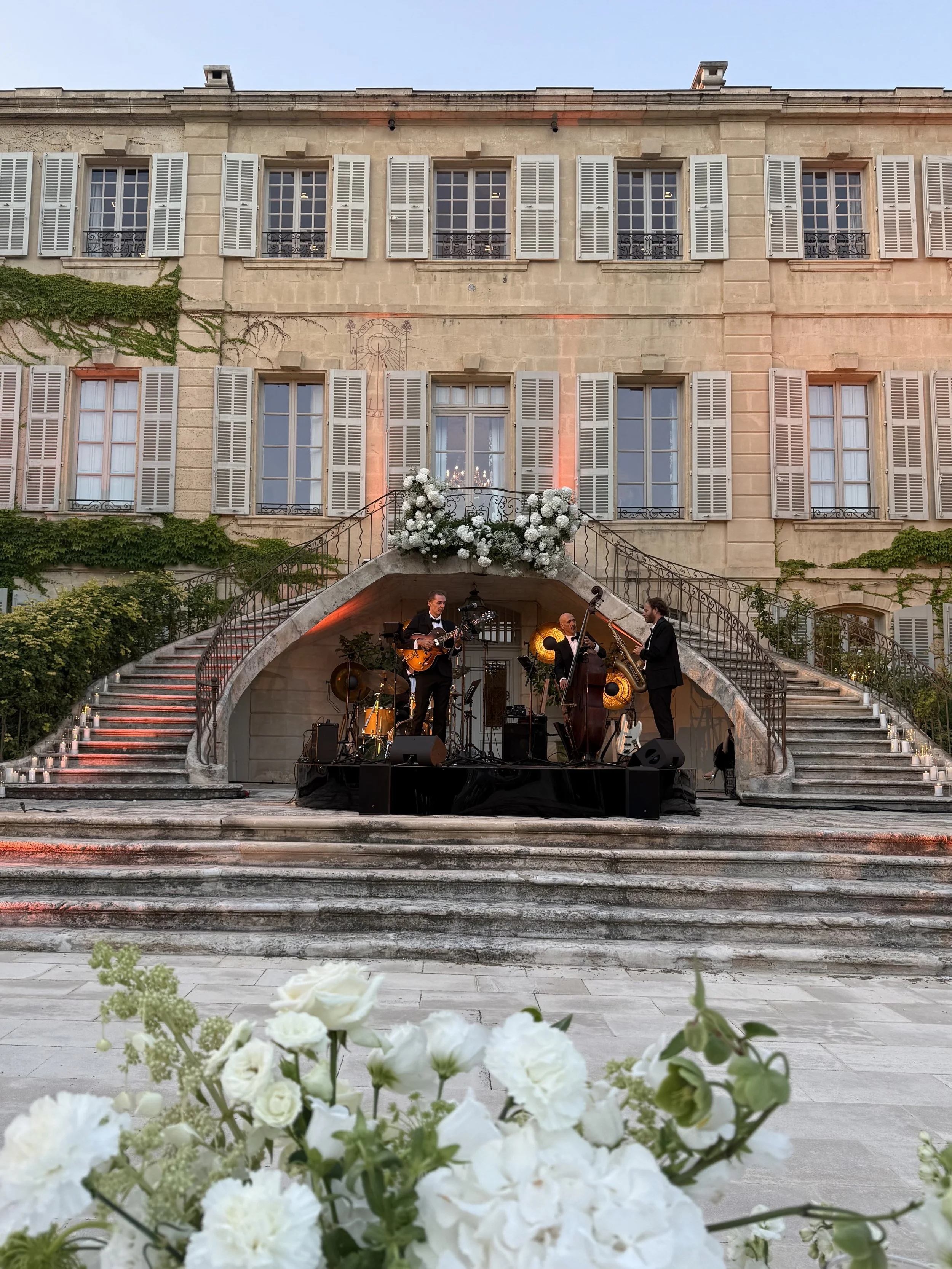 Live band performing outside Château d'Estoublon for a destination wedding 