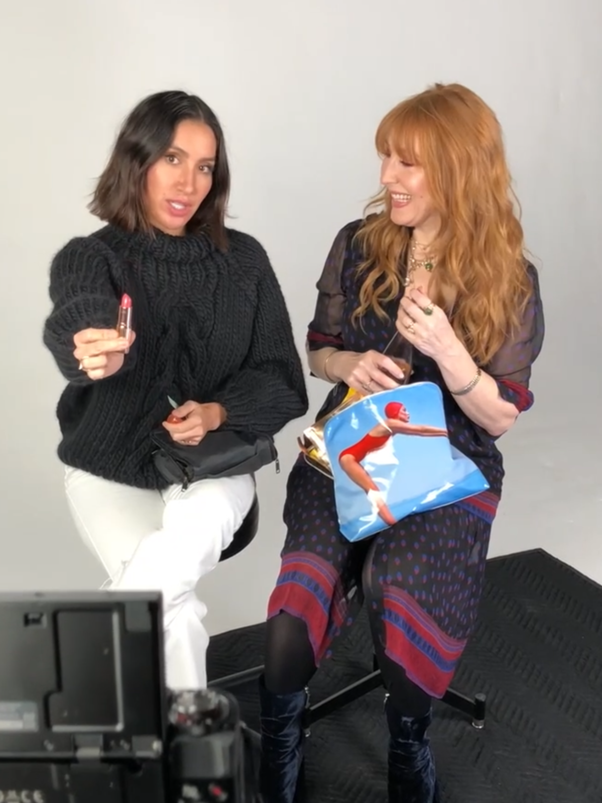 Charlotte Tilbury and Jen Atkin on a photoshoot, holding up a lipstick