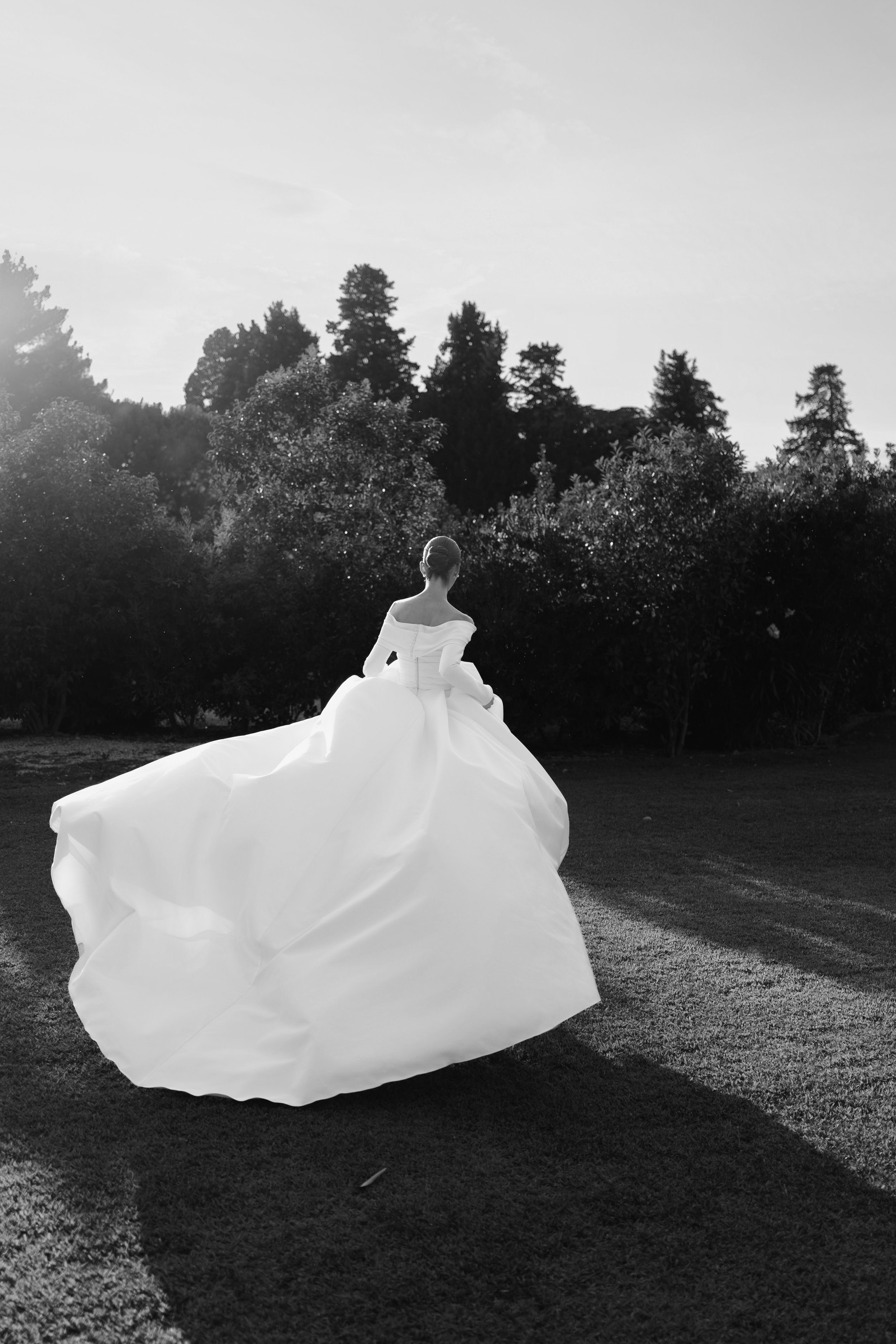 Bride in a full tulle gown at dusk — black and white destination wedding content