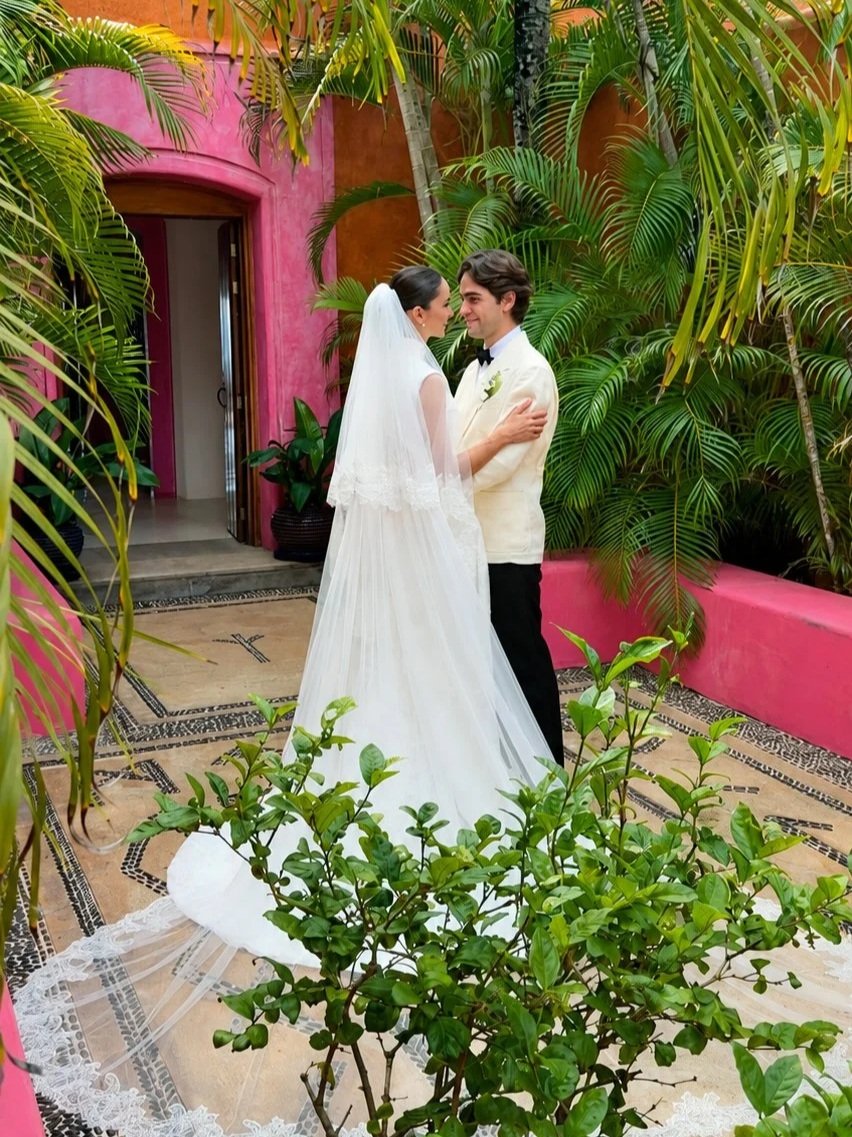Bride and groom embracing in a courtyard at a colourful destination wedding in Mexico