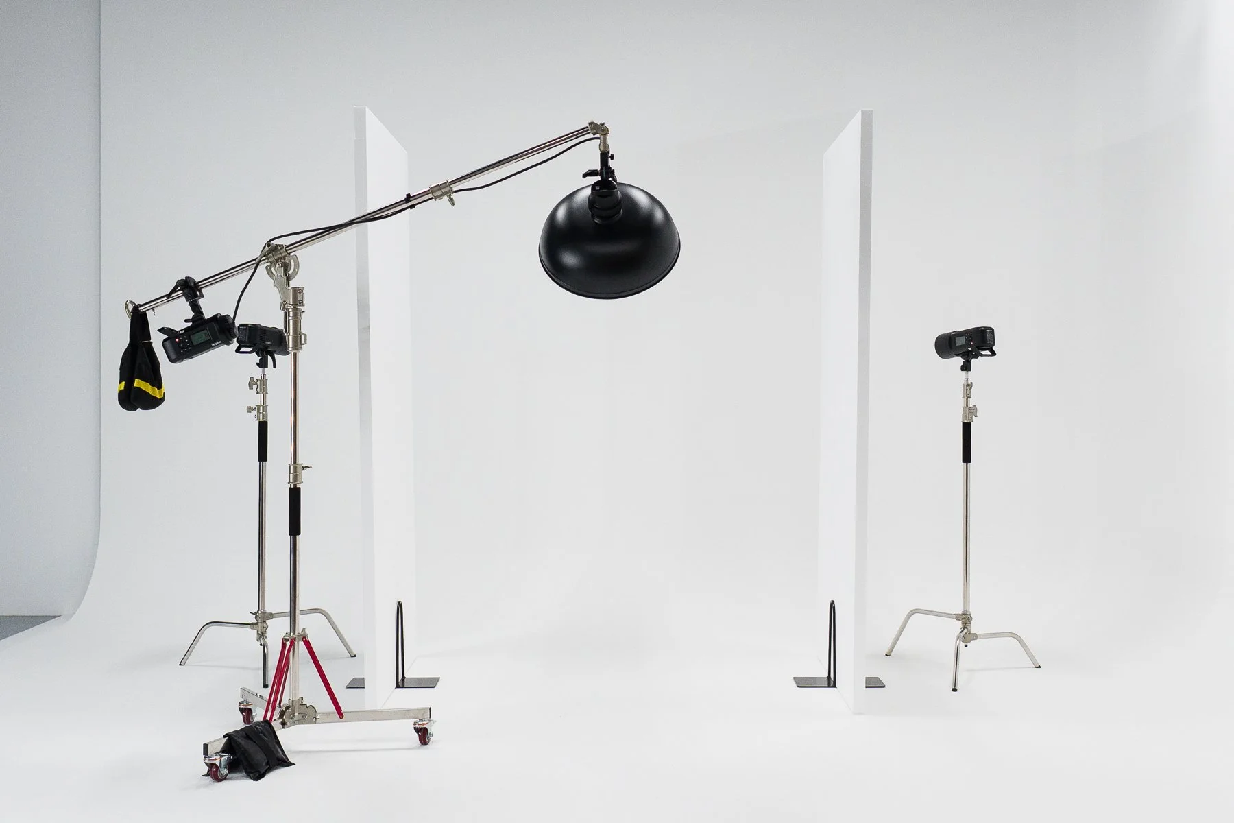 A studio strobe light with a large reflector attached, mounted on a light stand.