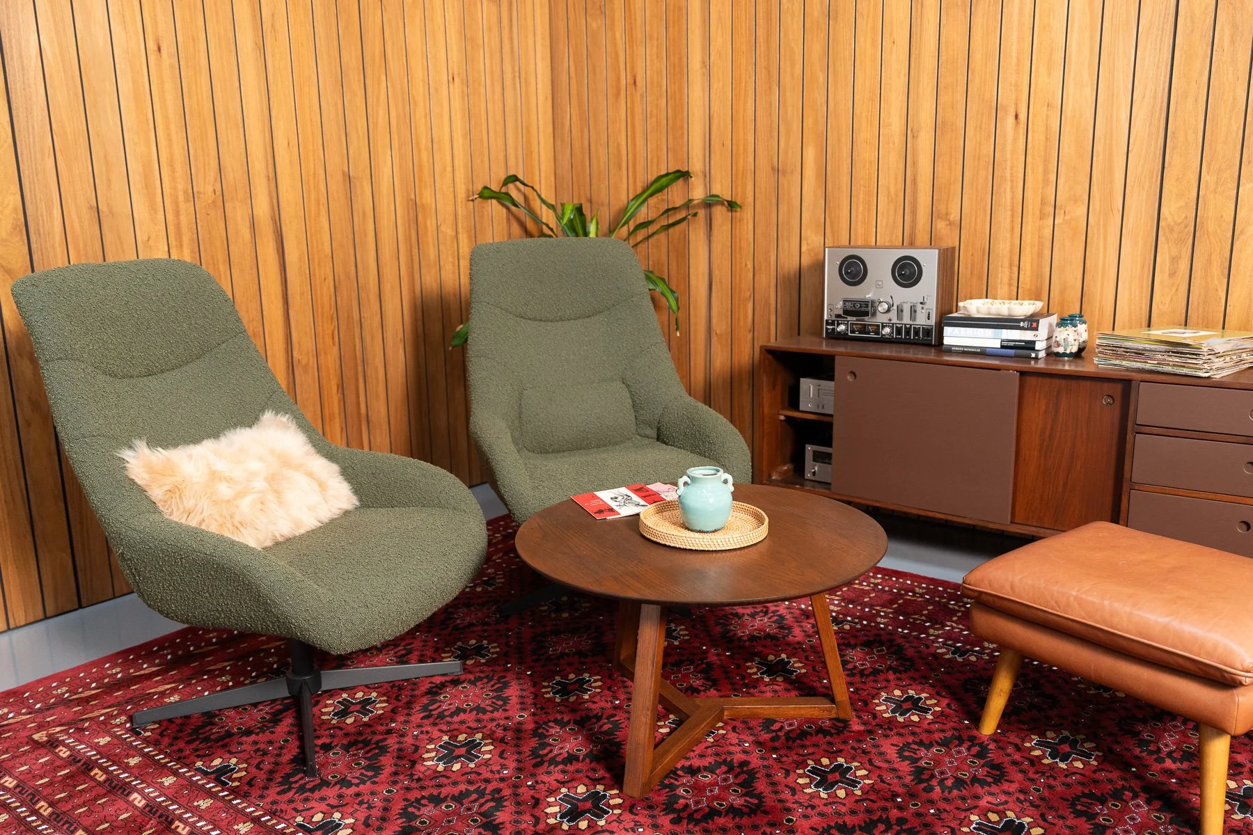 Pair of green bouclé armchairs with a relaxed mid-century inspired profile. Ideal for seated portraits, interviews, lifestyle shoots and styled interior sets.