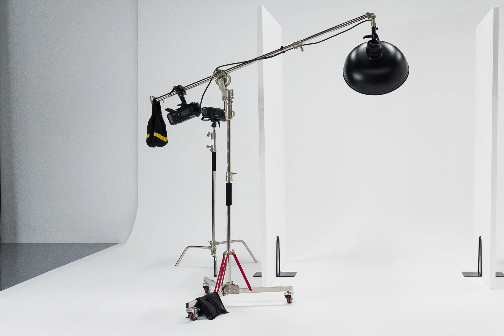 Rotatable Boom Stand — heavy-duty wheeled studio stand with a telescopic boom arm and rotatable mounting head. Ideal for positioning lights overhead or extending fixtures over sets while keeping the stand base out of frame. Maximum reach up to 4.2m