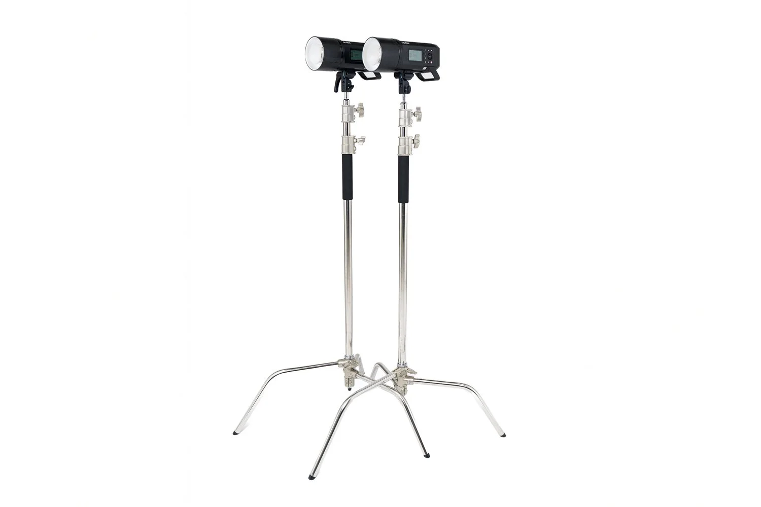 4 × Heavy-Duty C-Stands — versatile studio support stands for mounting lights, flags, reflectors and other grip equipment. Stable steel construction with adjustable height and grip heads for flexible positioning on set.