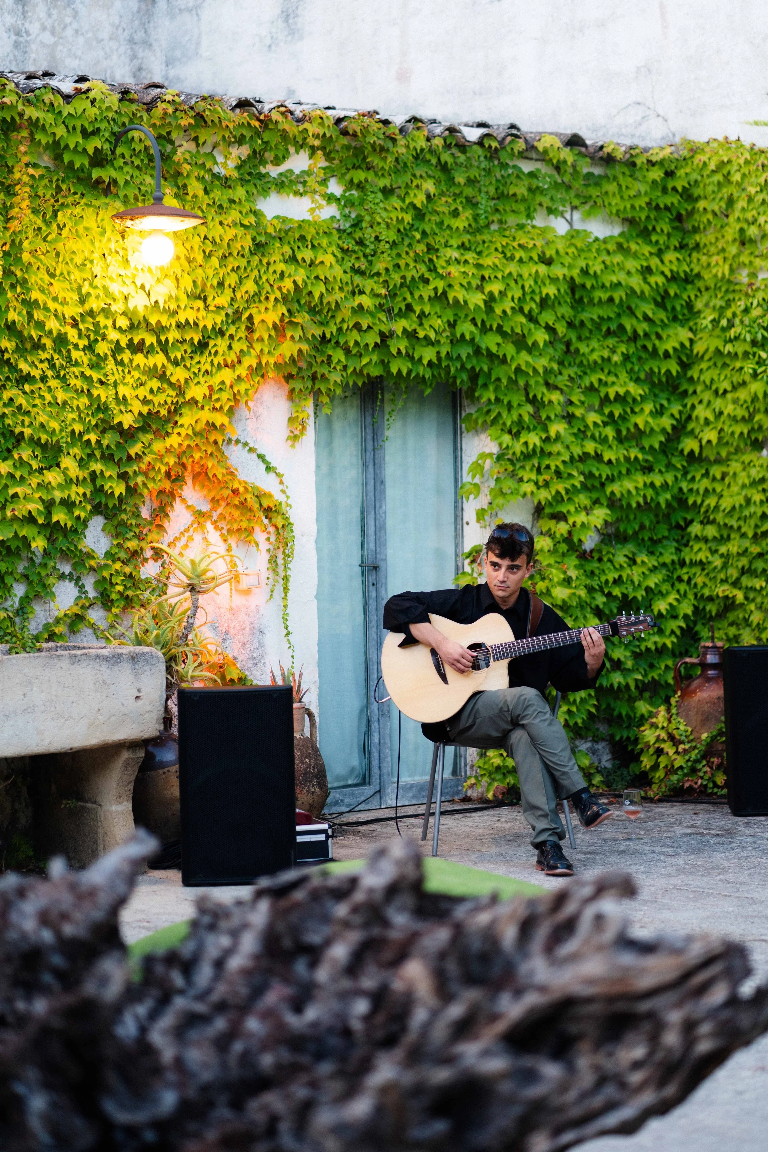 Un musicista sta suonando un sintetizzatore in un ambiente sotterraneo con archi in mattoni e colonne.