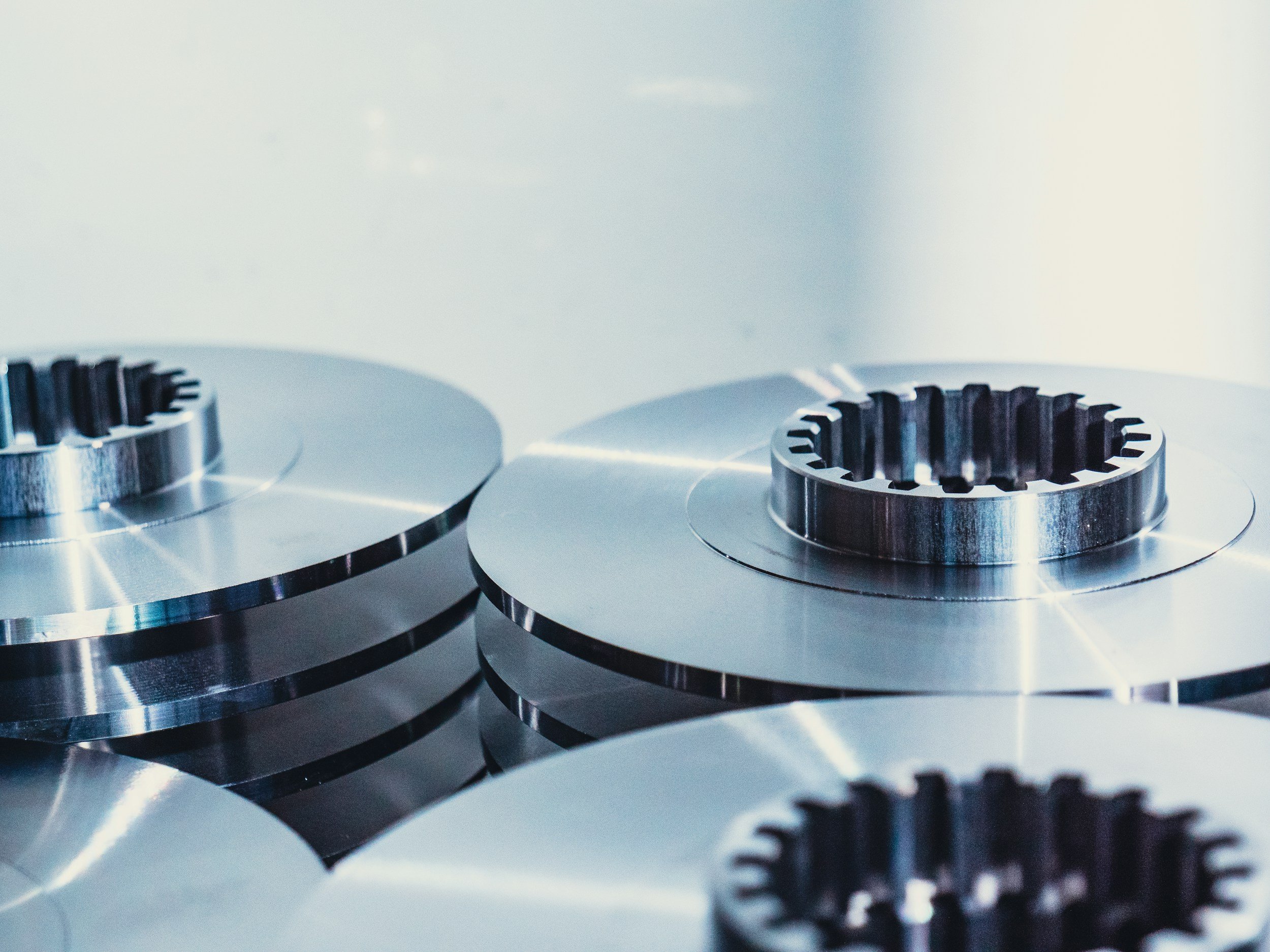 Close-up of metallic gears on a stove, reflecting light.