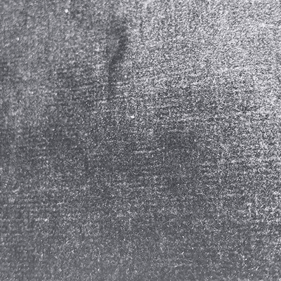 Close-up of a gray, textured concrete or asphalt surface.