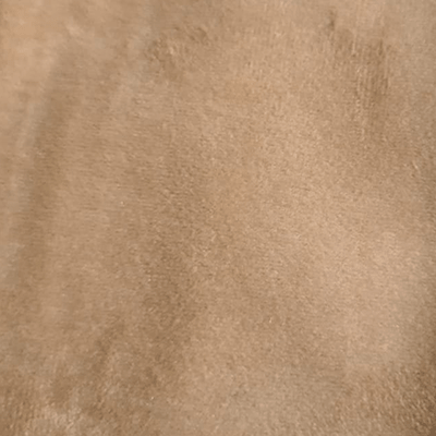 Close-up of a tan, textured fabric surface.