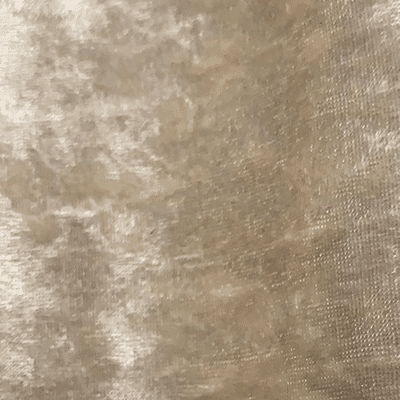 Close-up of a textured beige or gold fabric surface.