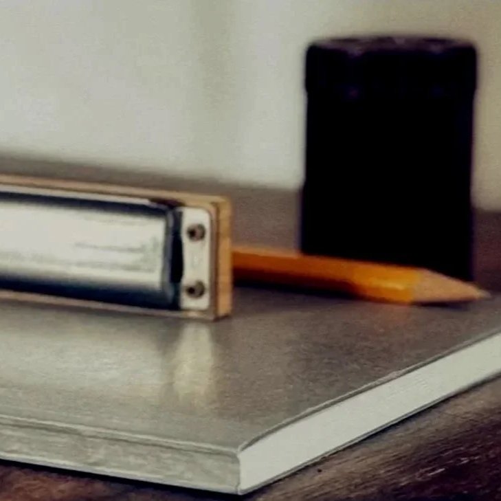 Ein Notizbuch, ein Bleistift, ein Radiergummi und ein Hefter auf einem Tisch.