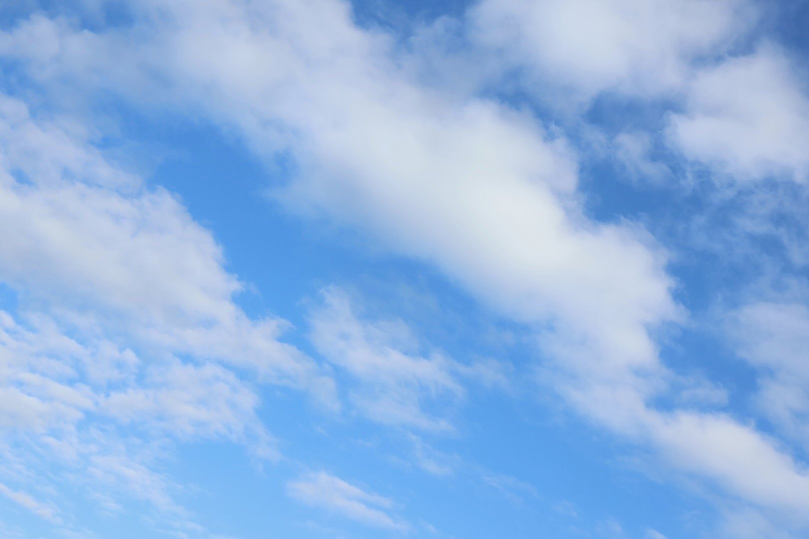 Blue sky with scattered white clouds.