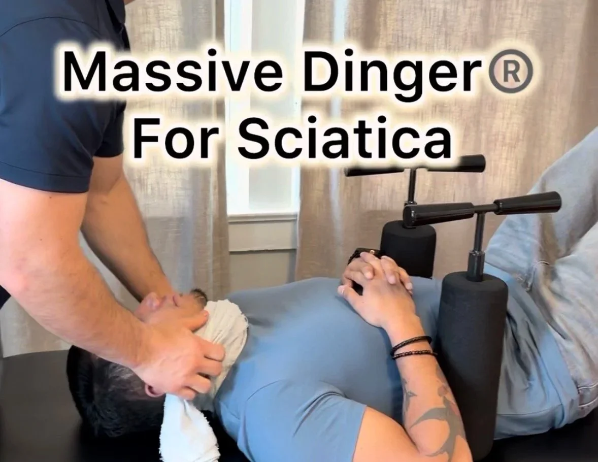 A person lying on a treatment table with therapy equipment around their neck, receiving chiropractic or physical therapy. A therapist is supporting their neck with a towel, and text overlay reads "Massive Dinger For Sciatica."